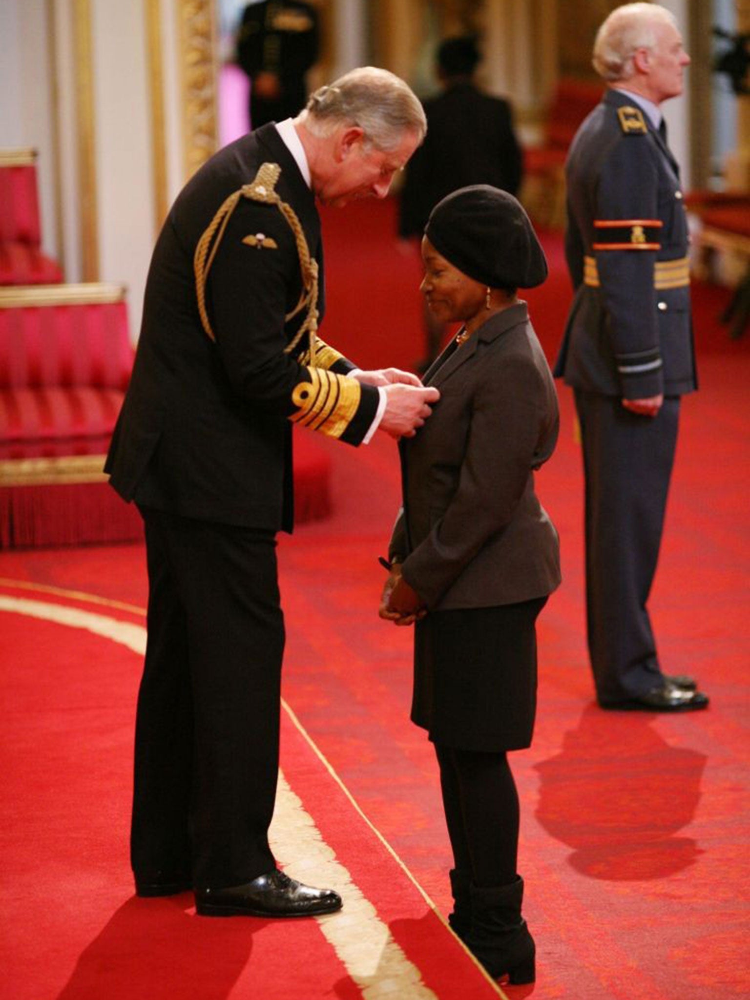 Greer being made an Officer of the British Empire (OBE) by Prince Charles at Buckingham Palace in London