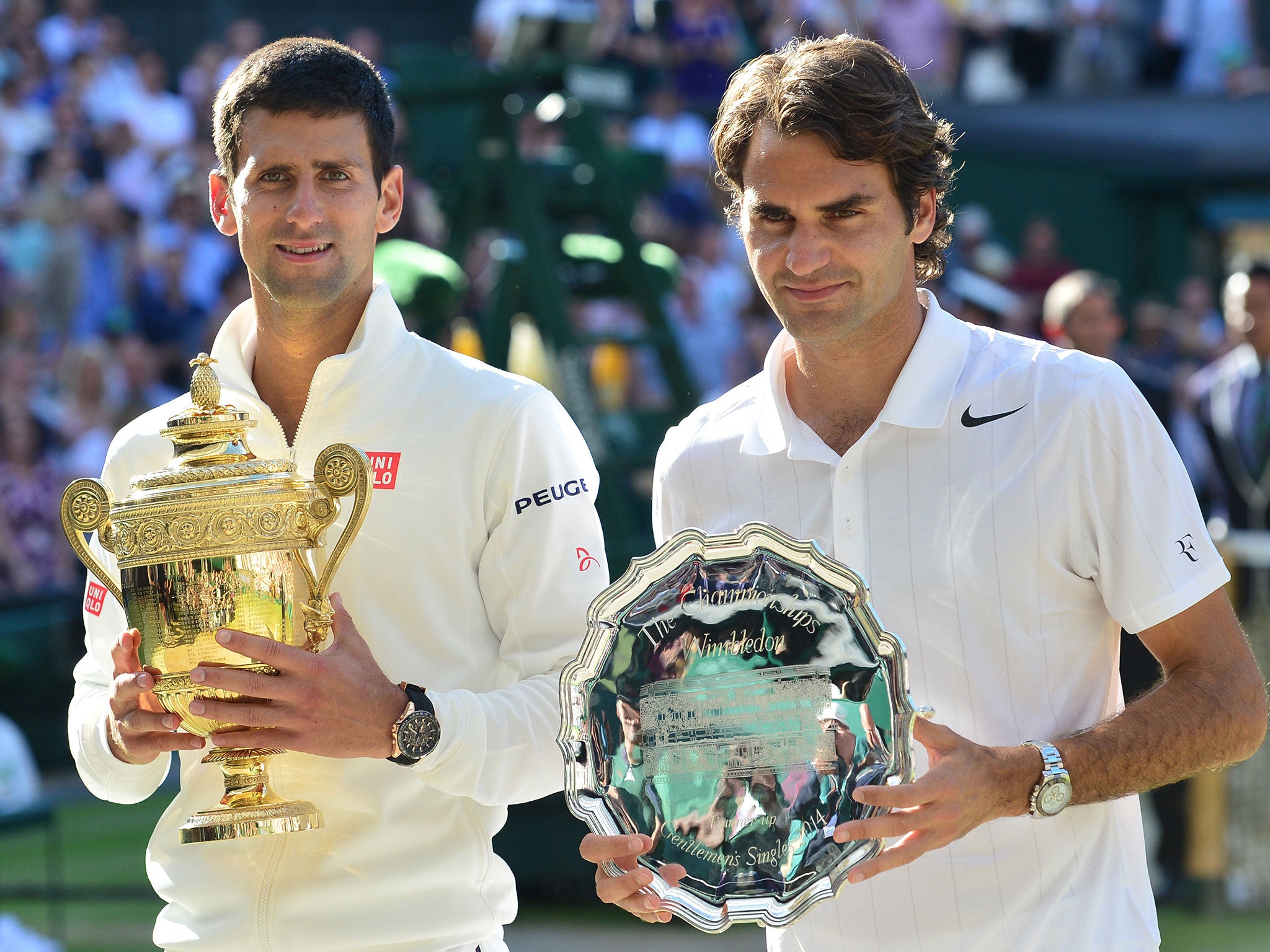 Novak Djokovic and Roger Federer pose with their trophies after the final