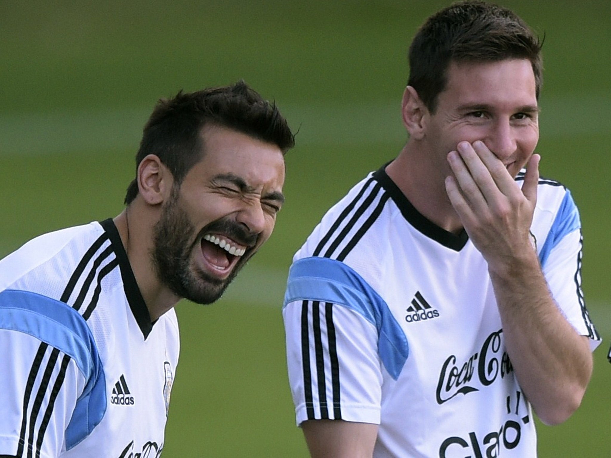 Ezequiel Lavezzi and Lionel Messi share a joke during training