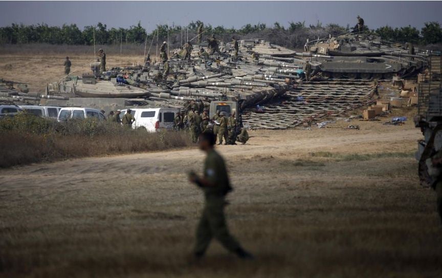 Israeli soldiers gather at a military staging area