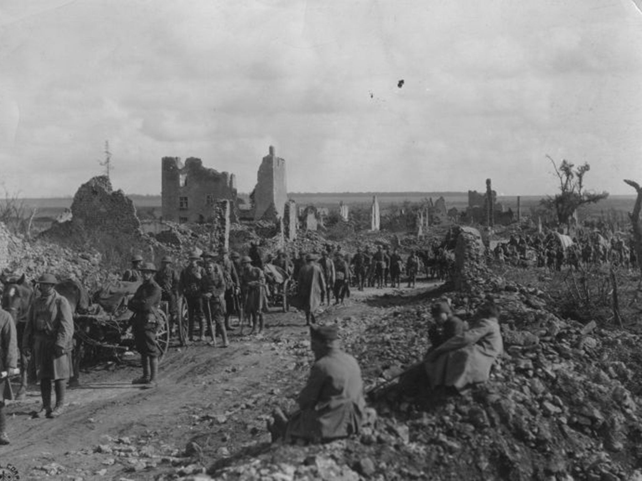 American soldiers of the 18th Infantry Machine Gun Battalion advance through the ruins of St Baussant on their way to the St. Mihiel Front