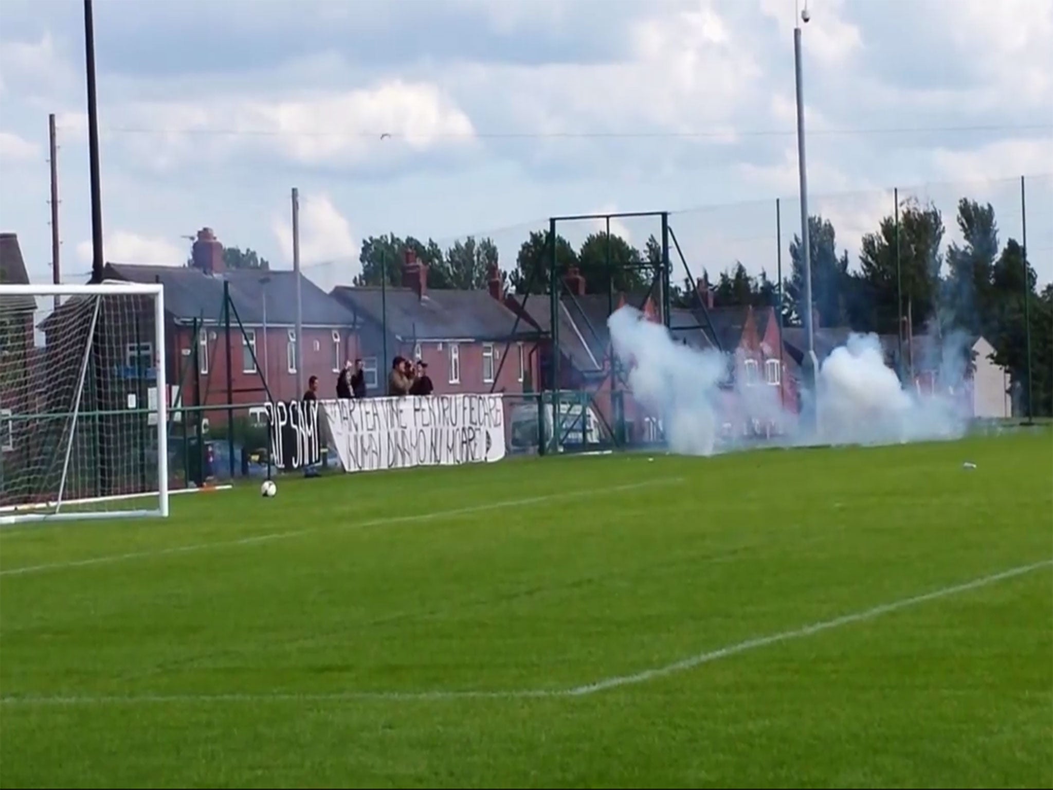 Dinamo Bucharest fans throw fireworks onto the pitch during a pre-season friendly with Hearts in Lancashire