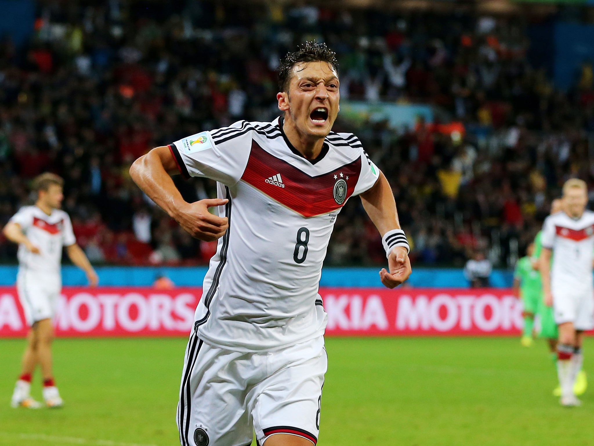 Mesut Ozil celebrates his goal for Germany against Algeria