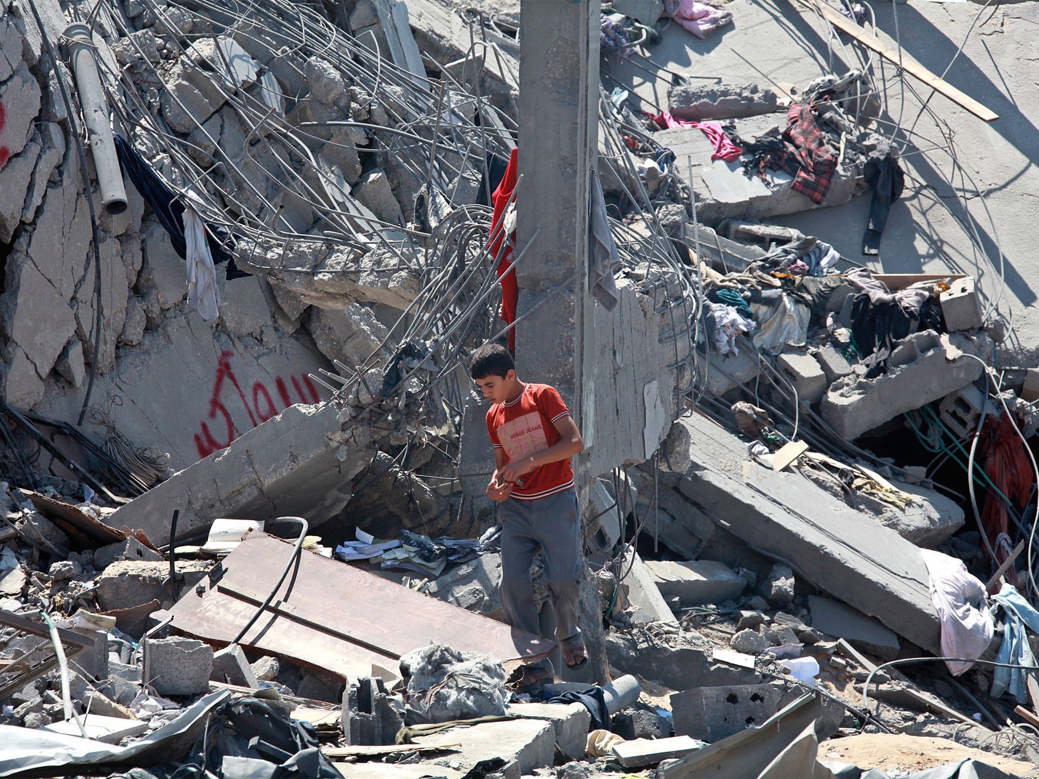 A Palestinian in the rubble of a destroyed home following an Israeli airstrike in Khanyounis, southern Gaza Strip