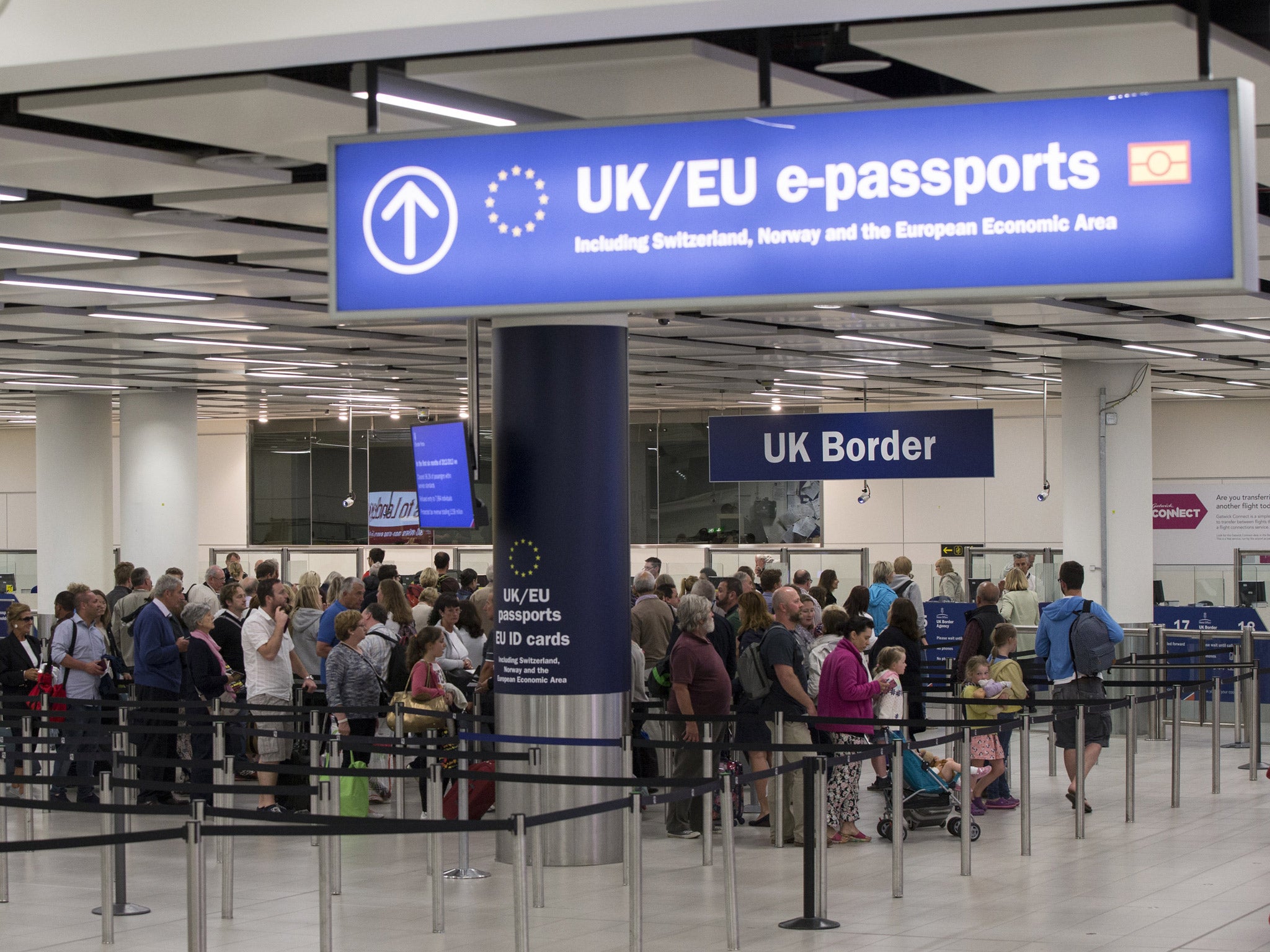 Border Force check the passports of passengers arriving at Gatwick Airport