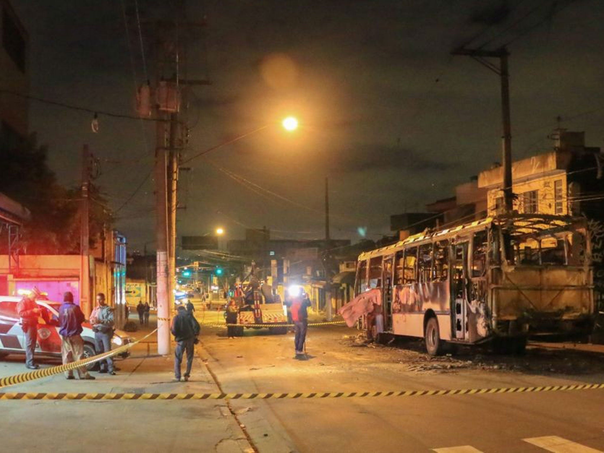 A burnt-out bus outside a garage in Sao Paulo