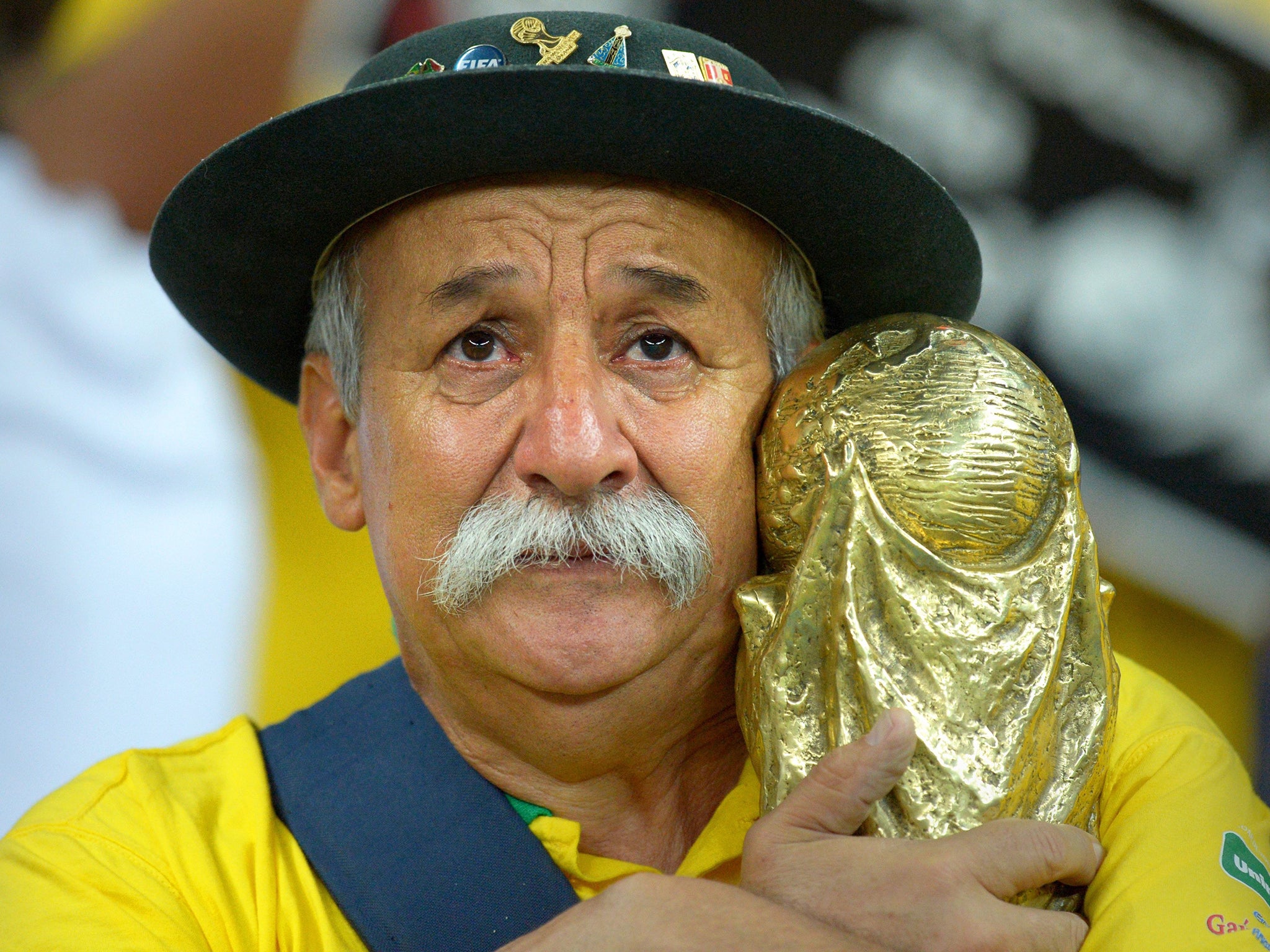 A Brazilian fan shows his dejection after the semi final defeat