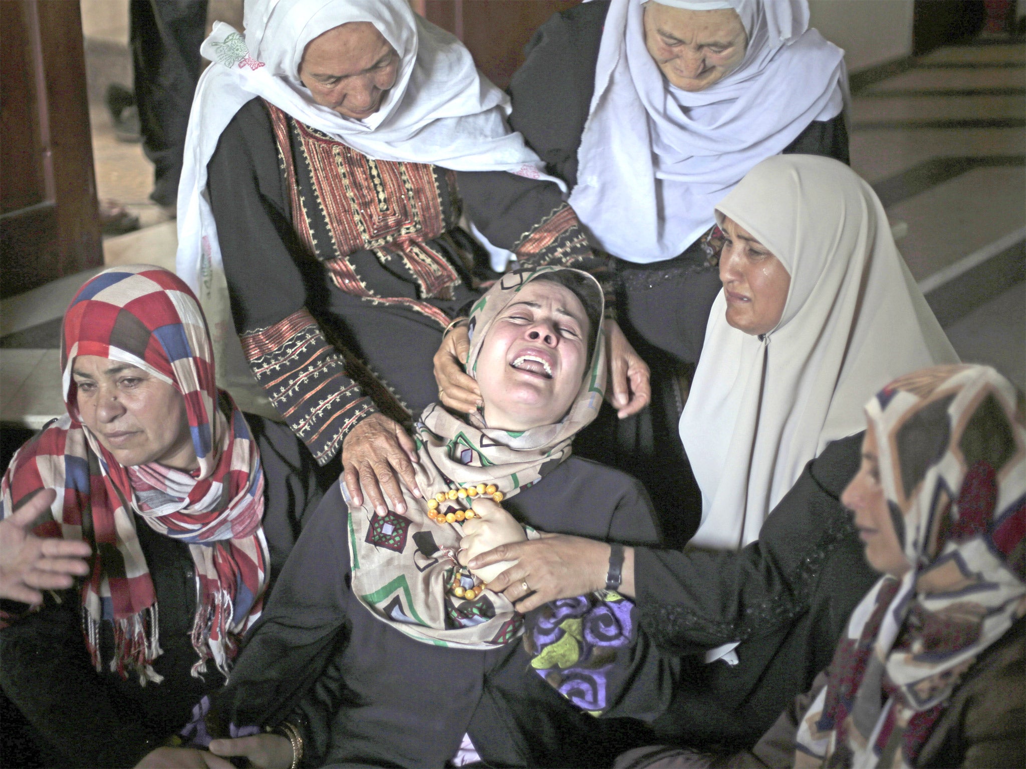 Palestinians mourn five relatives who died in an Israeli missile attack on Tuesday in Beit Hanoun