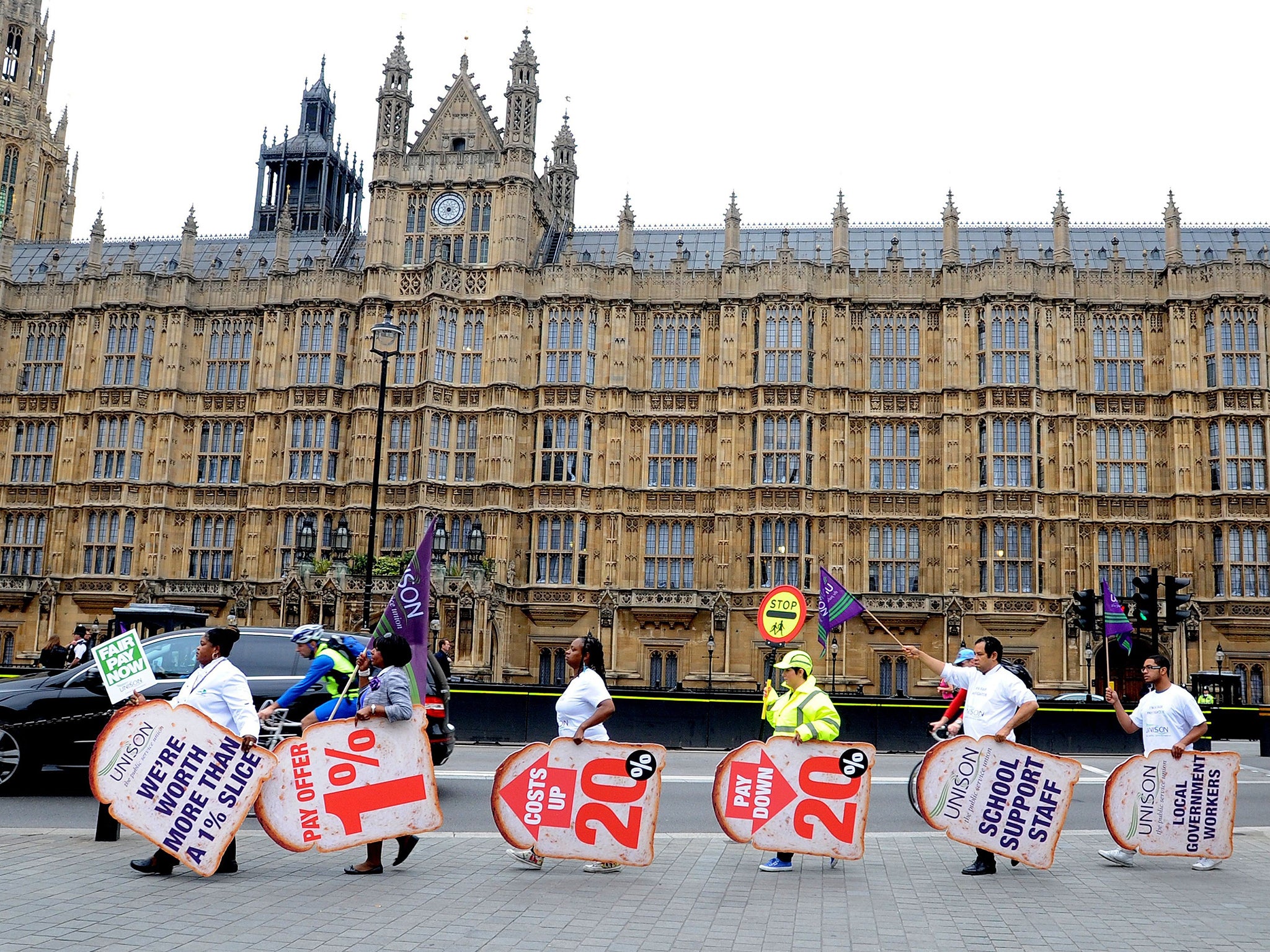 Public sector workers and members of Unison gather outside the Houses of Parliament in central London as they take part in the one-day walkout as part of bitter disputes over pay, pensions, jobs and spending cuts
