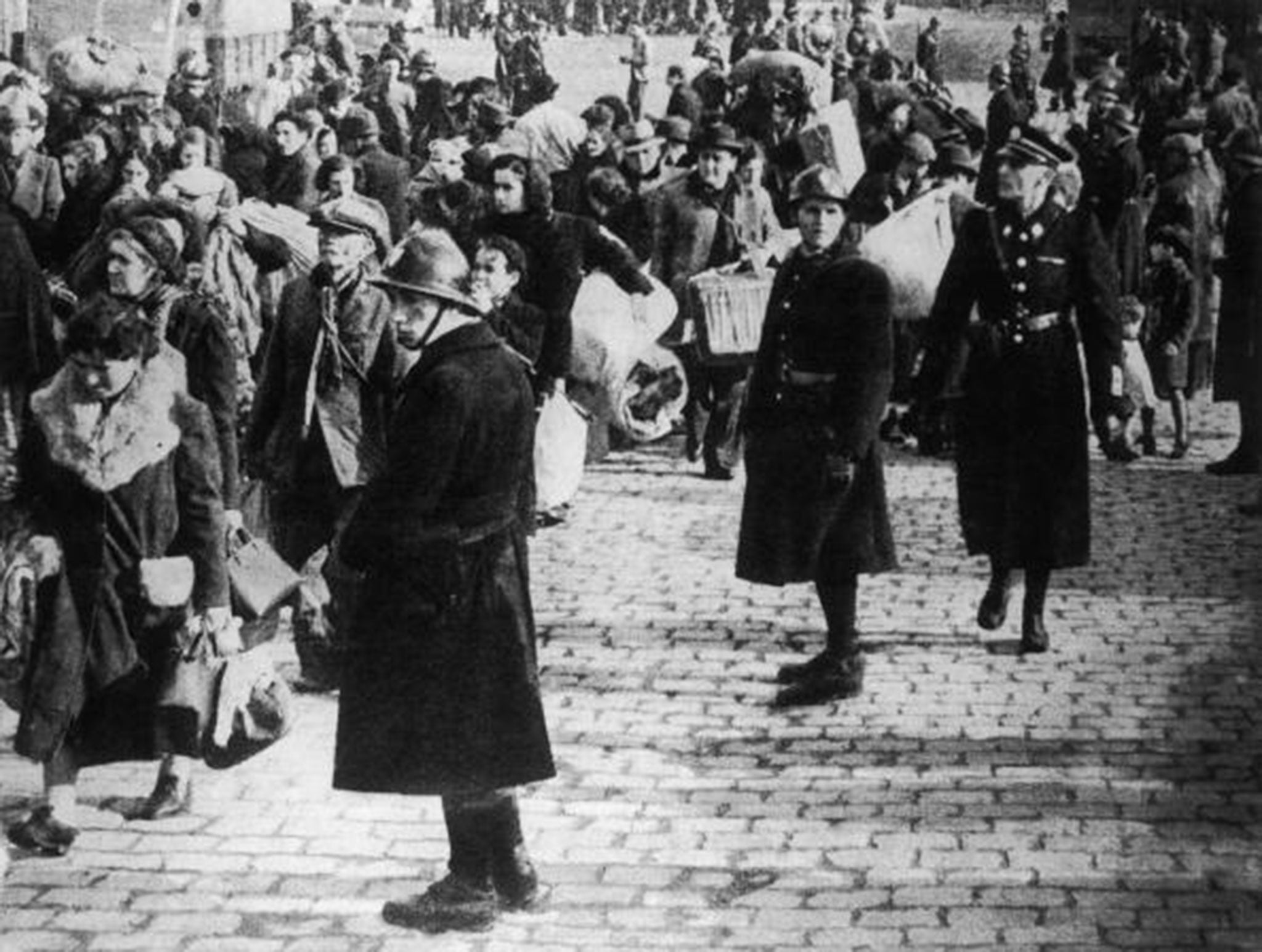 French Vichy troops and German SS officers oversee the compulsory evacuation of 40,000 people from the old port quarter of Marseille, 1943