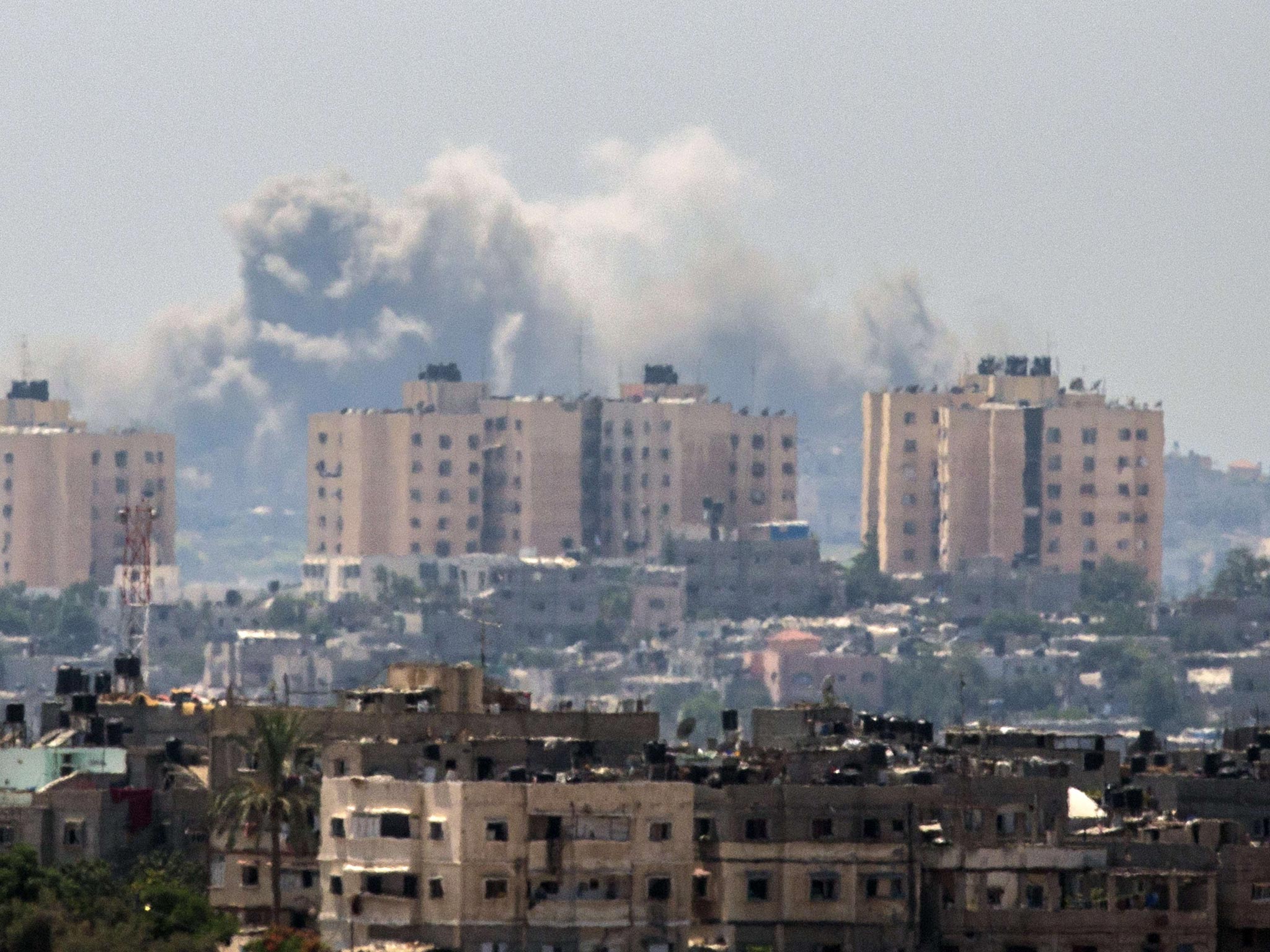 Smoke billows from buildings following an Israeli air strike in Gaza City