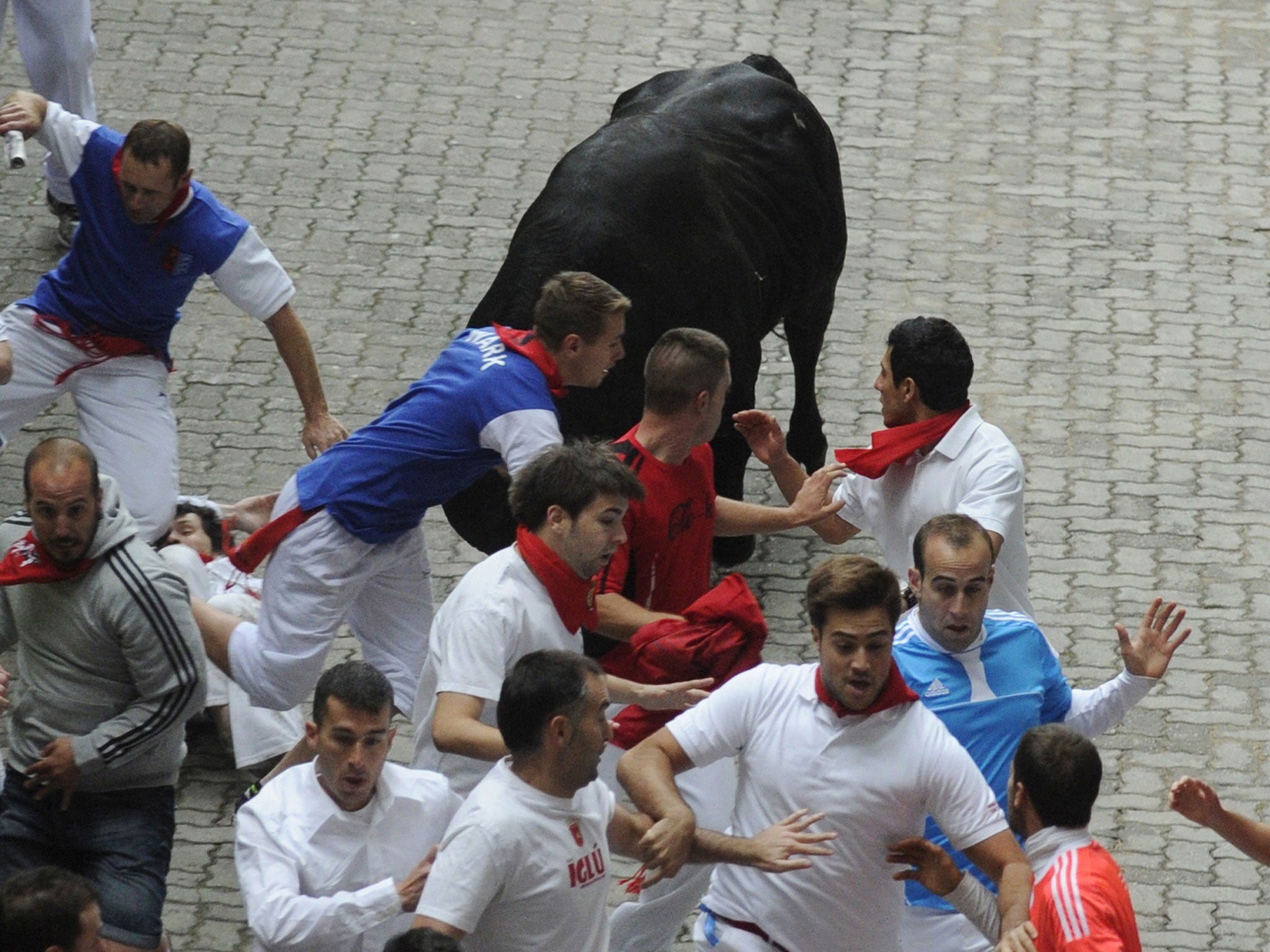 The American lies on the ground moments before he is gored