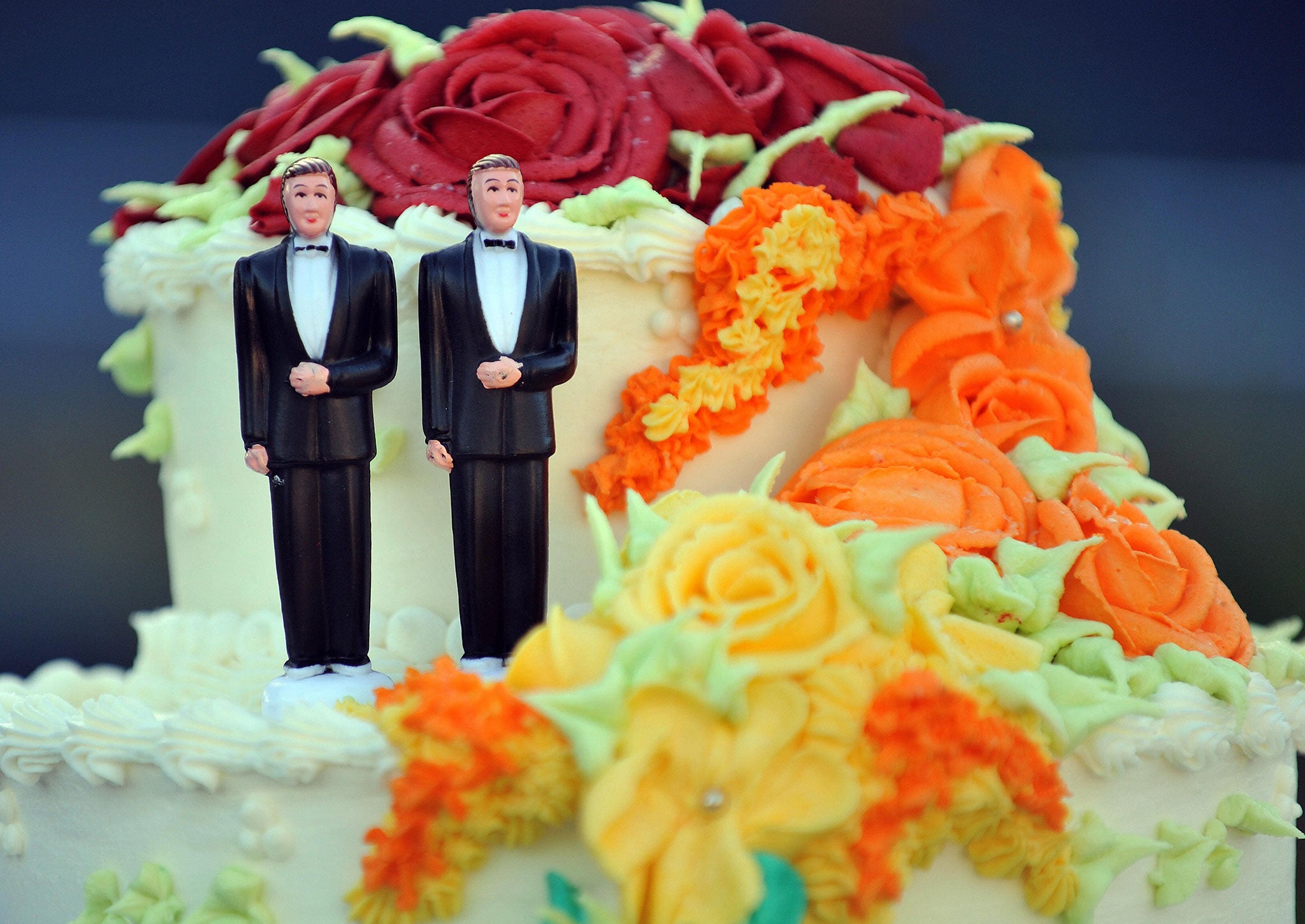 A wedding cake with statuettes of two men is seen during the demonstration