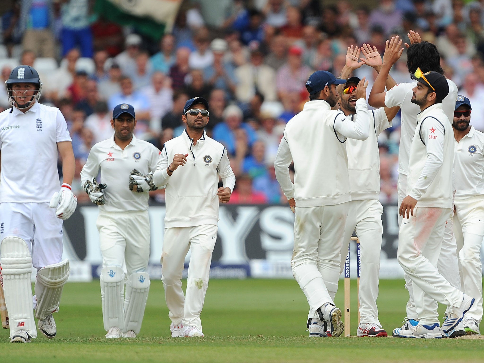 India's players celebrate after taking the wicket of England's Gary Ballance