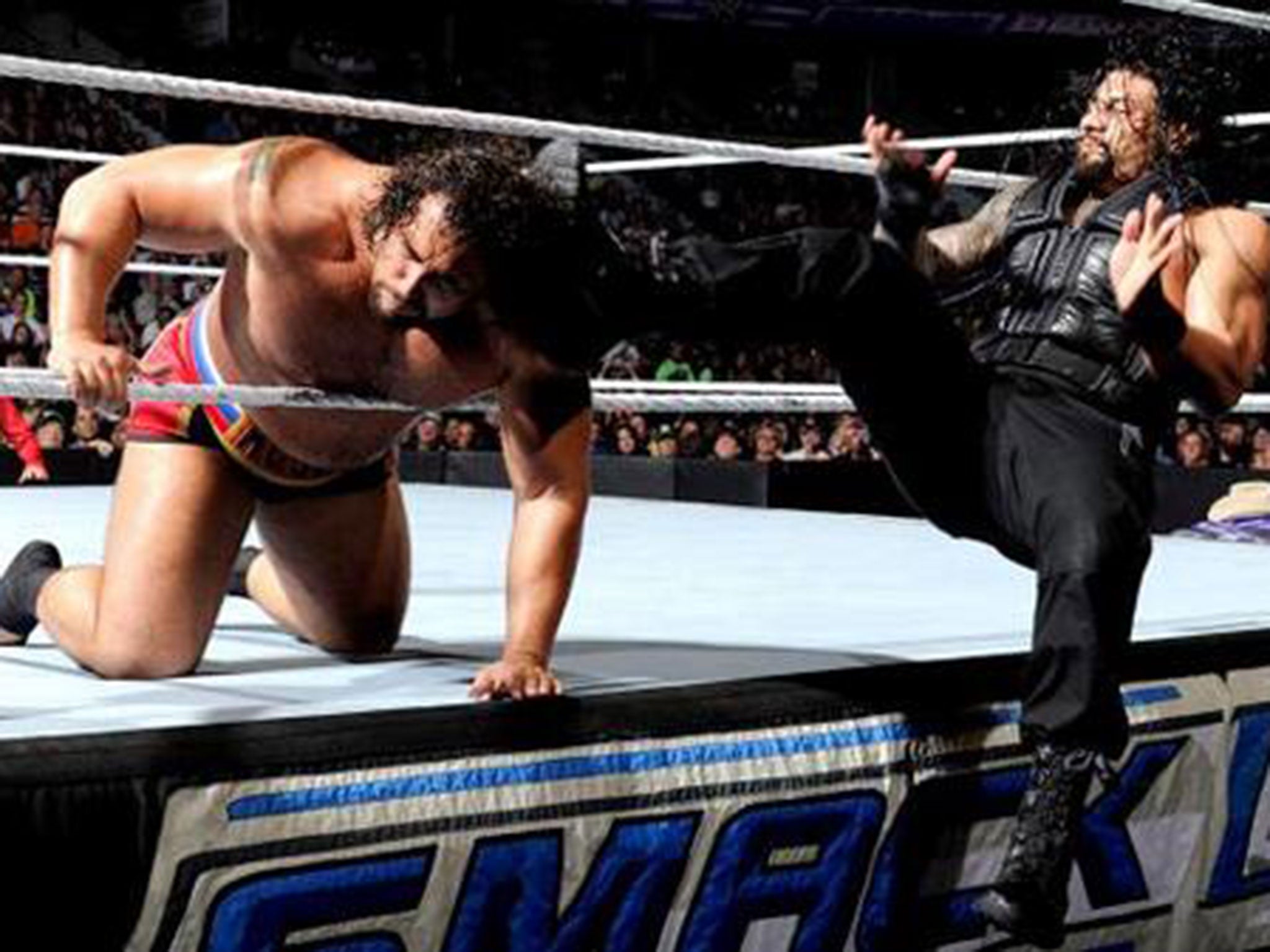 Roman Reigns kicks Rusev in the head