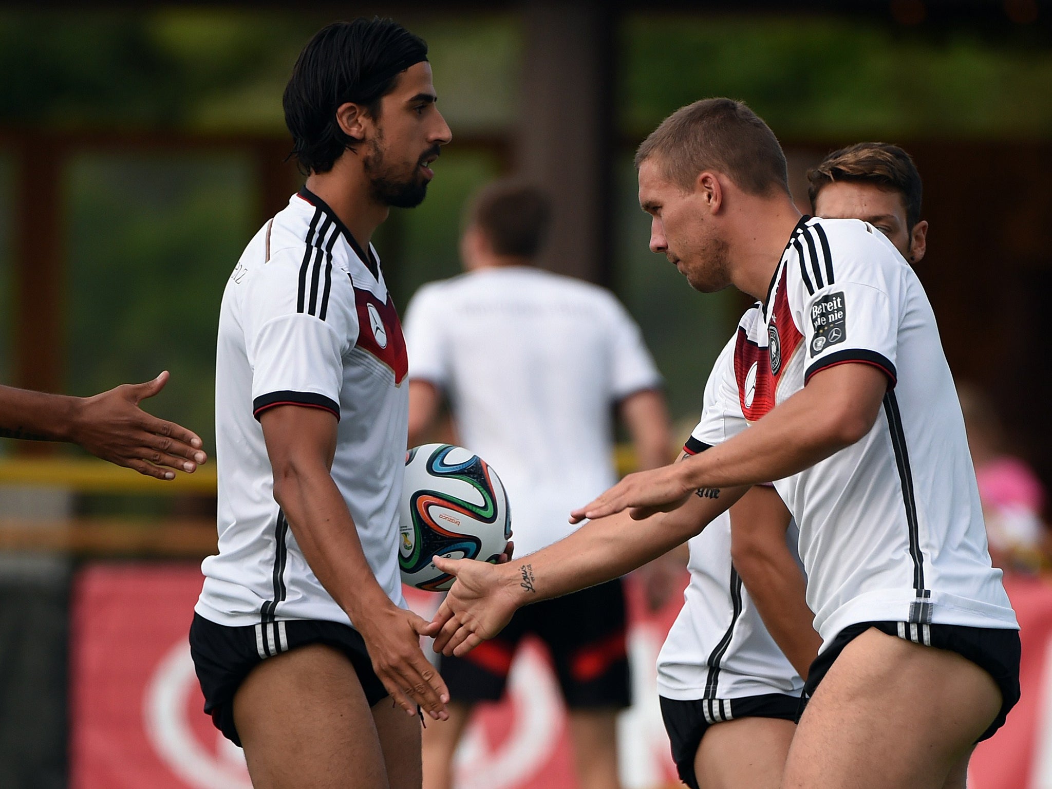 Germany's Sami Khedira and Lukas Podolski take part in a training session ahead of the World Cup final