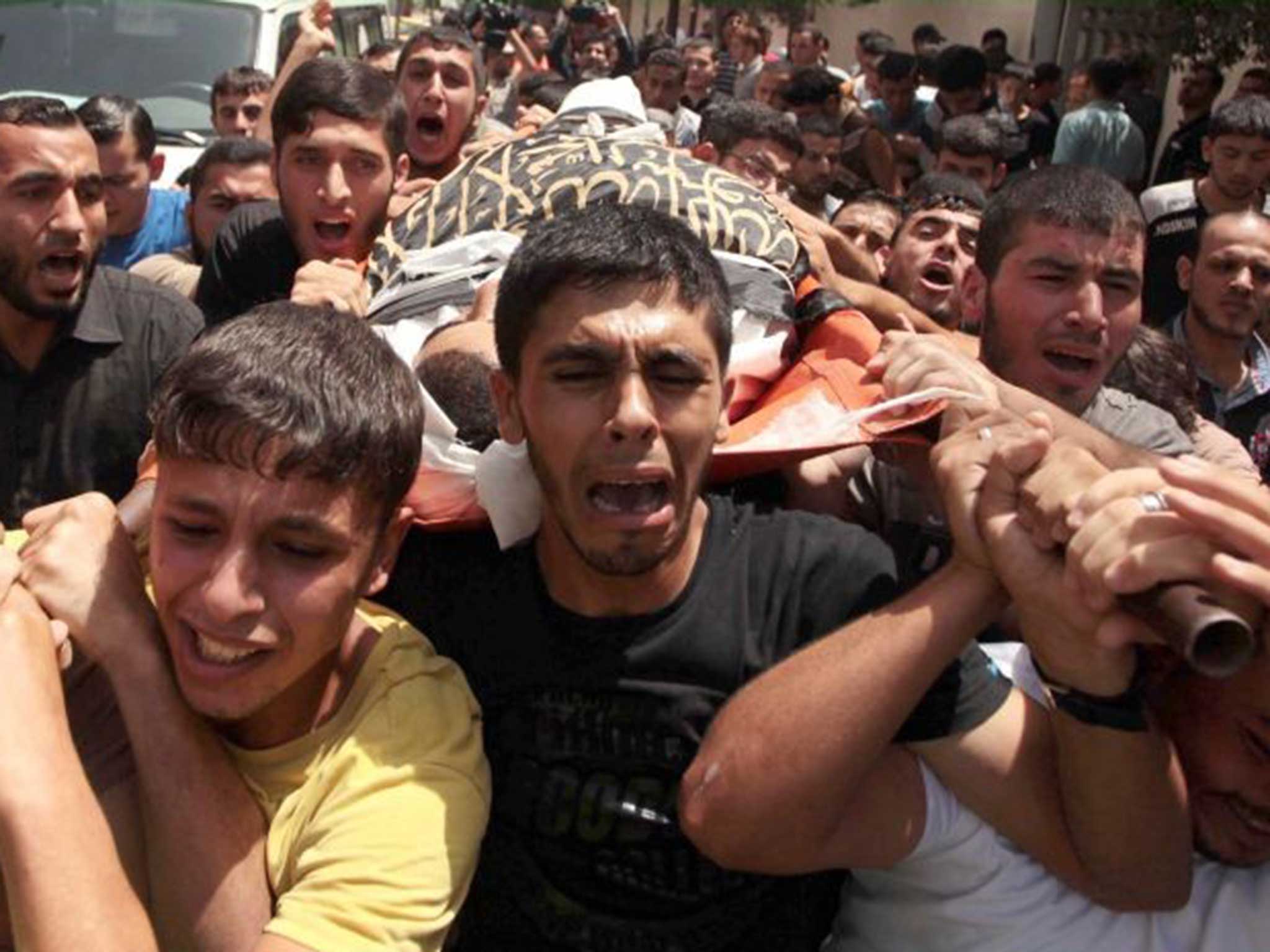 Tearful relatives of Mohammed Sweilem, killed in an Israeli airstrike staged to Jabalia Refugee Camp, attend the funeral ceremony