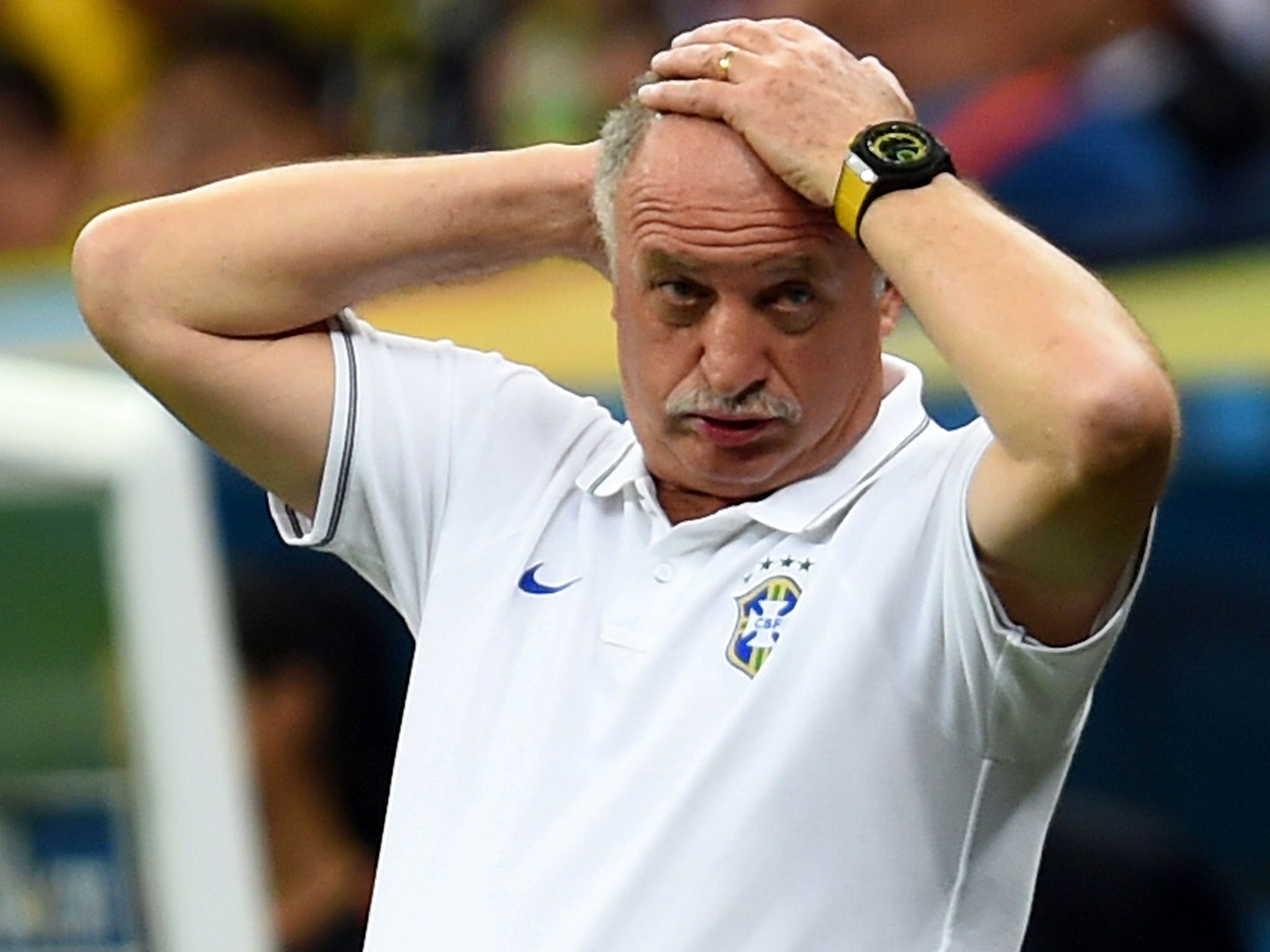 Luiz Felipe Scoalri holds his hands on his head after watching Brazil succymb to a 3-0 defeat to the Netherlands