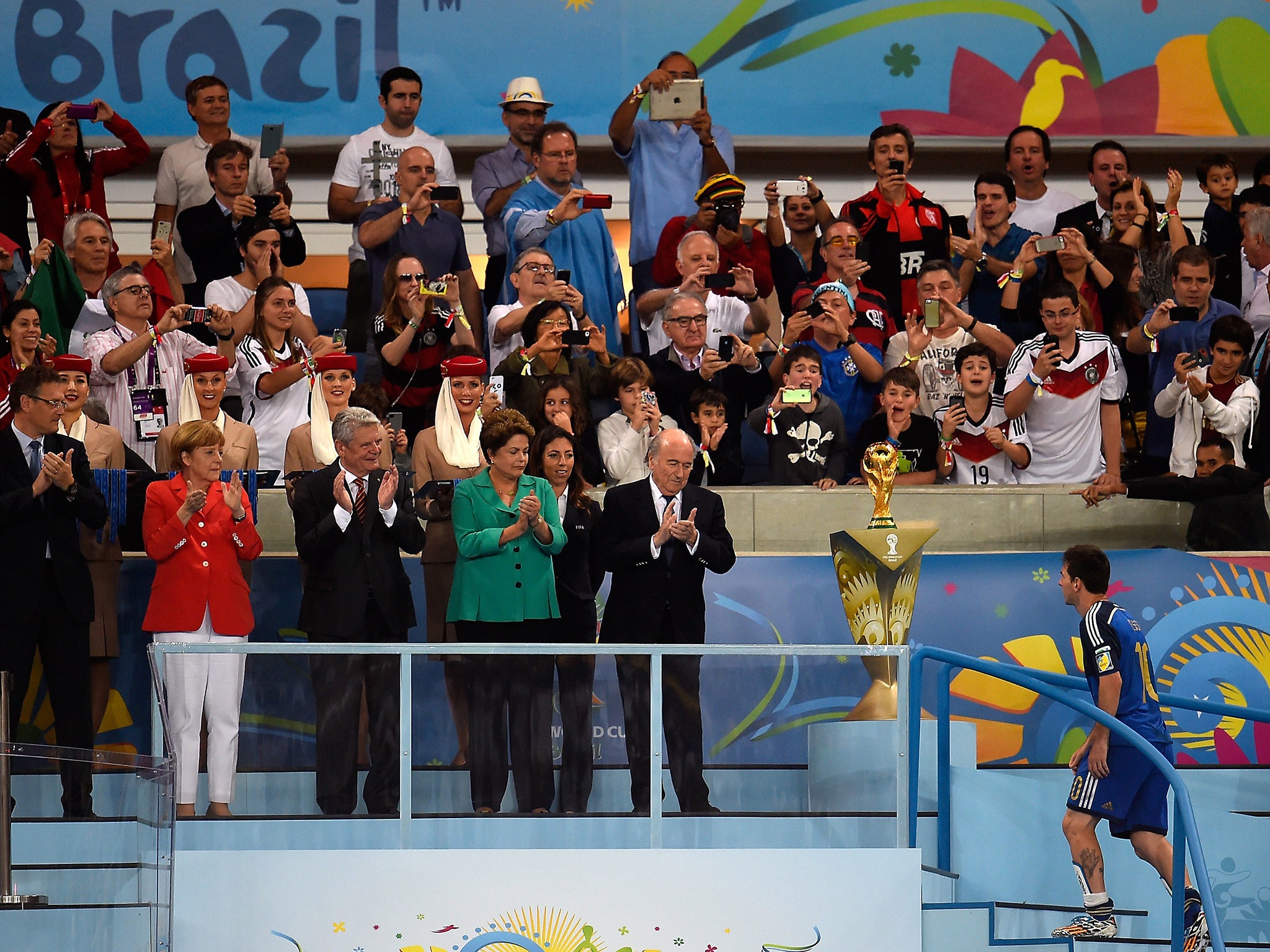 Lionel Messi walks past the World Cup trophy to collect the Golden Ball award