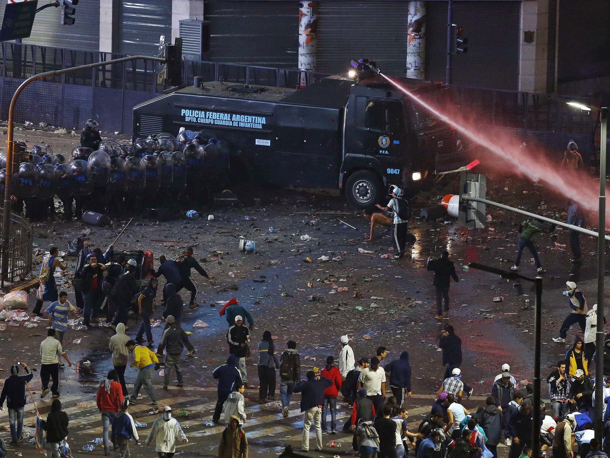 Argentina's fans clash with riot police after Argentina lost to Germany in their 2014 World Cup final in Brazil, at a public square viewing area in Buenos Aires July 13, 2014