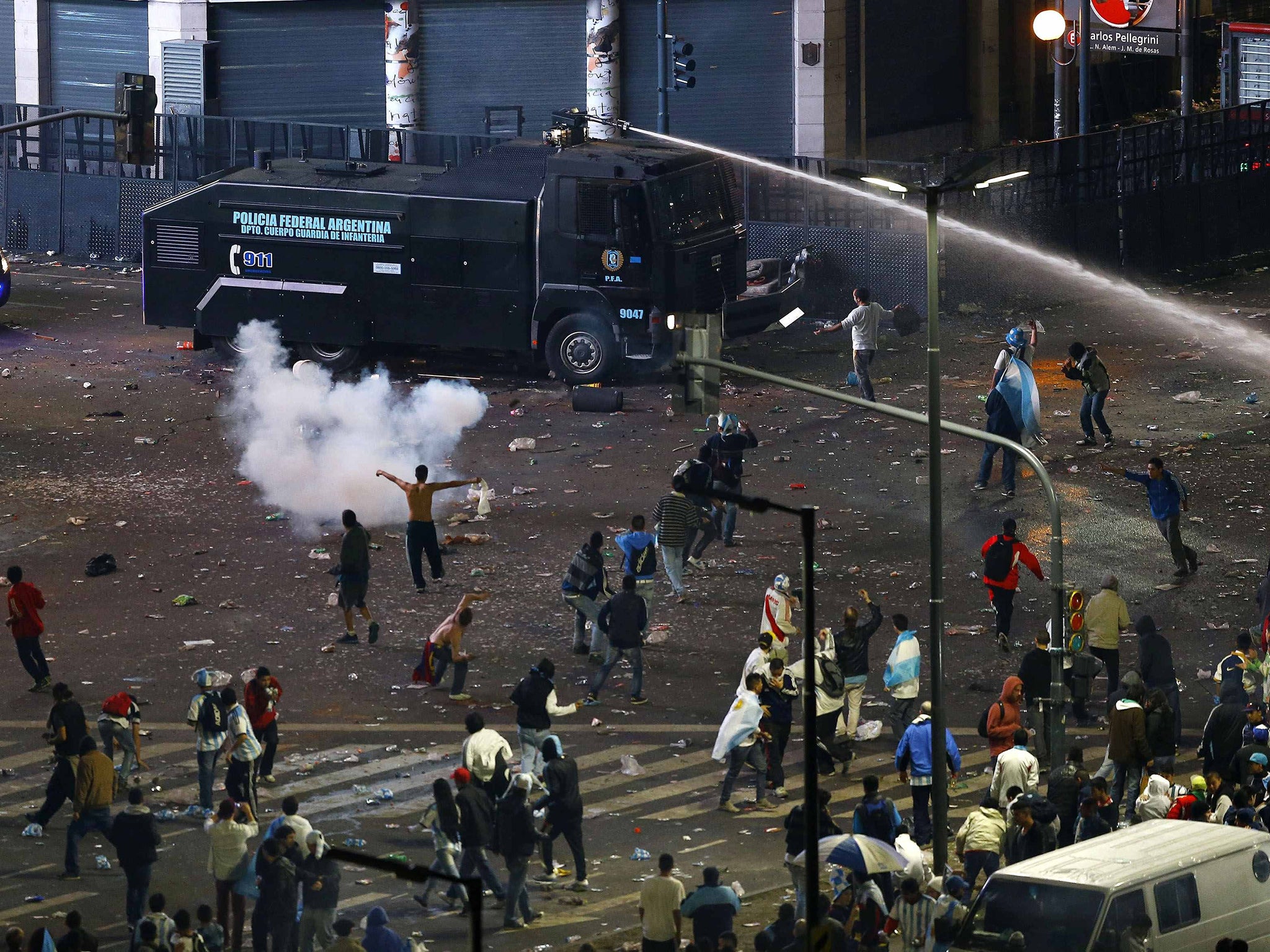 Argentina's fans clash with riot police after Argentina lost to Germany in their 2014 World Cup final soccer match in Brazil, at a public square viewing area in Buenos Aires