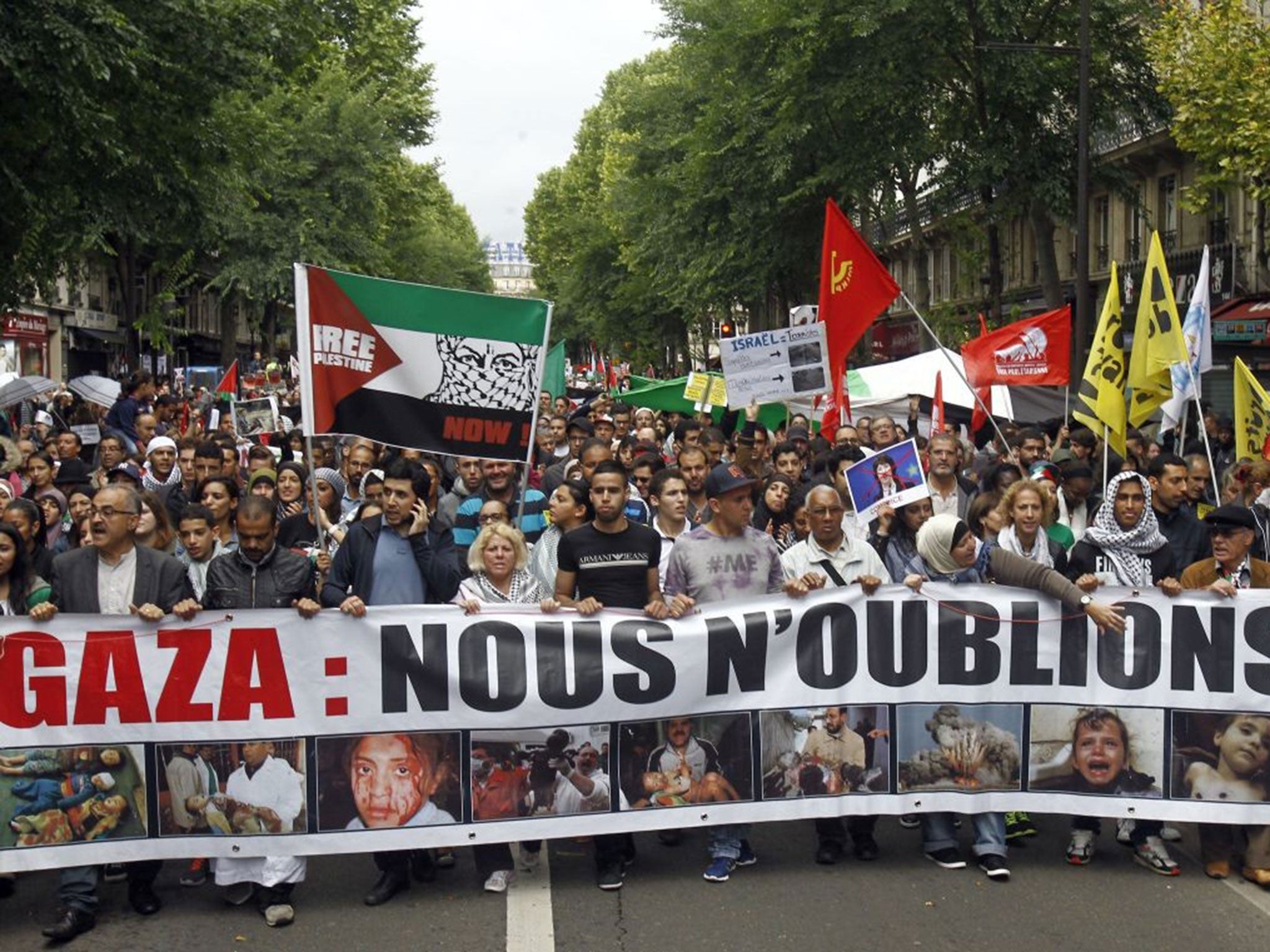 Thousands of pro-Palestinian demonstrators holding banners and chanting anti Israeli slogans walk in Paris, Sunday July 13,