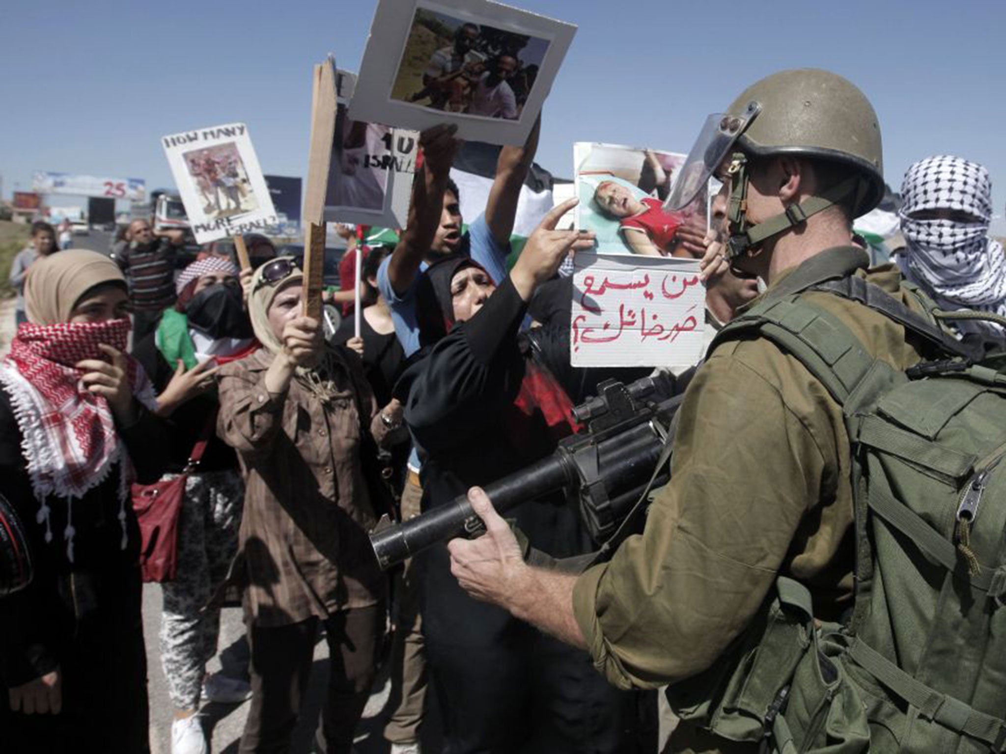 Palestinians protest at the Israeli manned checkpoint at the entrance to the northern Palestinian city of Nablus, in the occupied West Bank