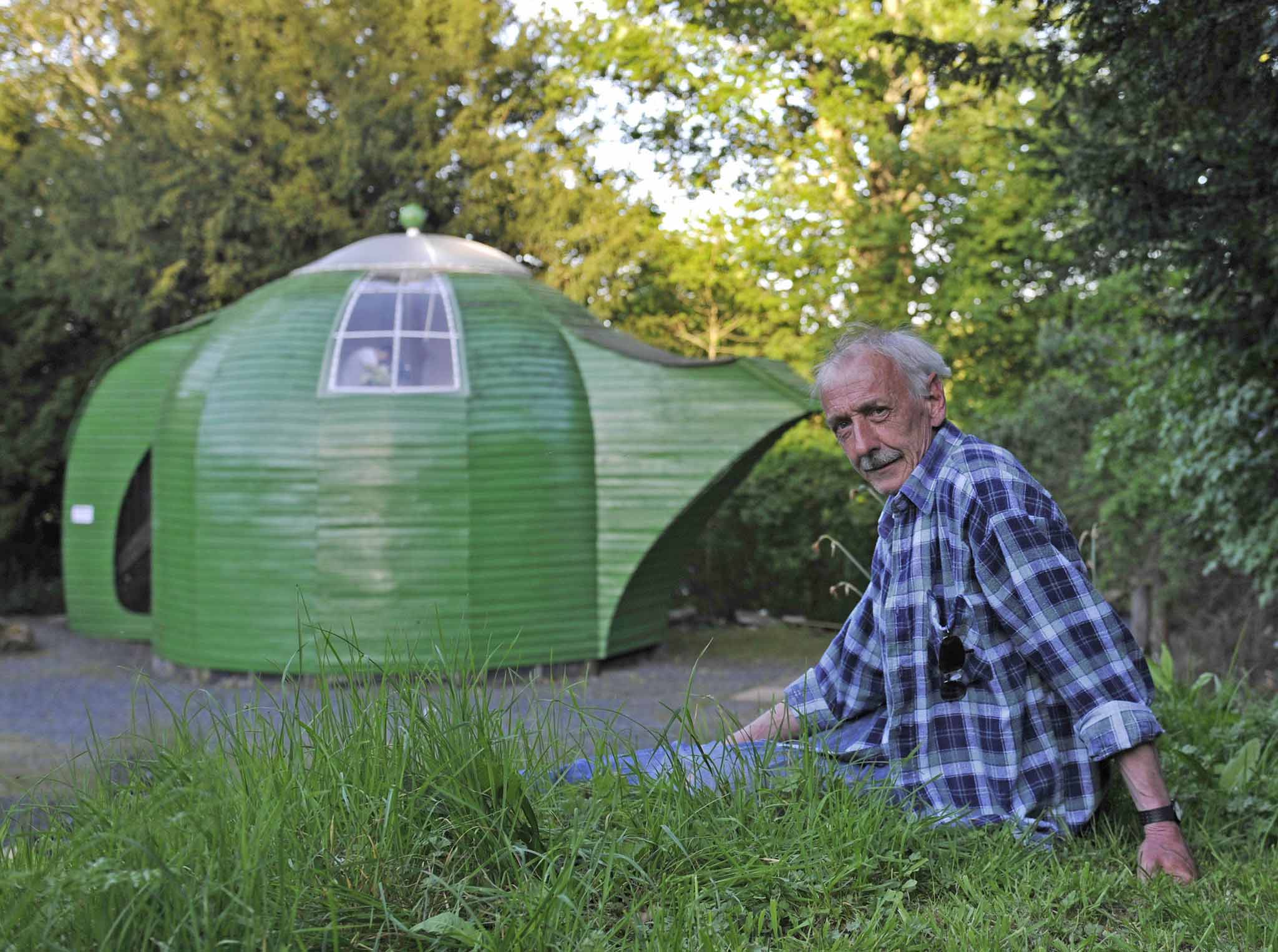 Teapot. Owned by Ian Hunter, aged 59 from Melrose, Scotland. Built entirely from reclaimed materials, the ground level is used as a drying shed for timber with a summer house on the upper level accessed by steps through the teapot handle. The lid of the t