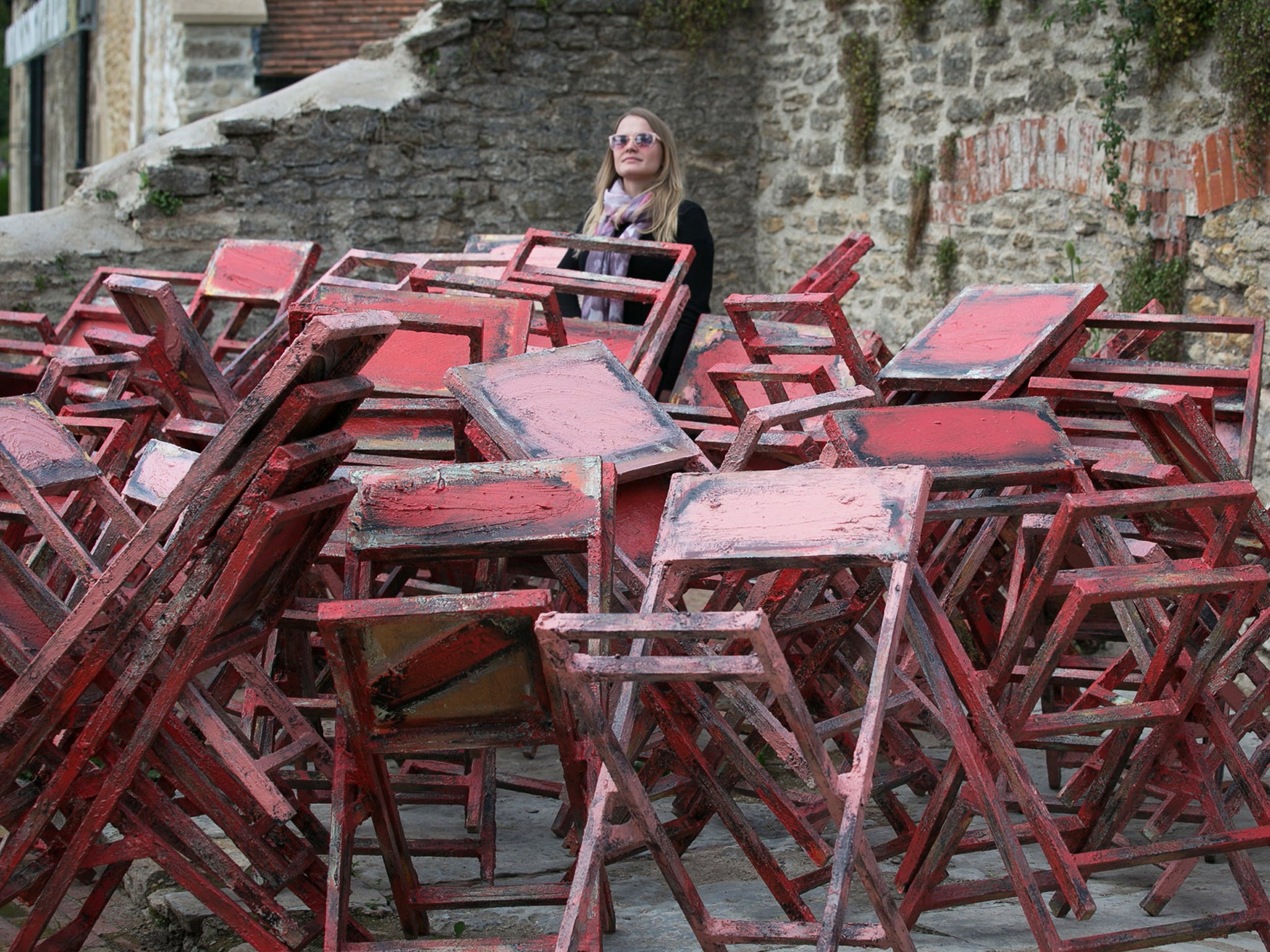 A visitor looks at Phyllida Barlow's untitled stacked chairs, part of the inaugral exhibition at Hauser &amp; Wirth Somerset in Bruton in Somerset