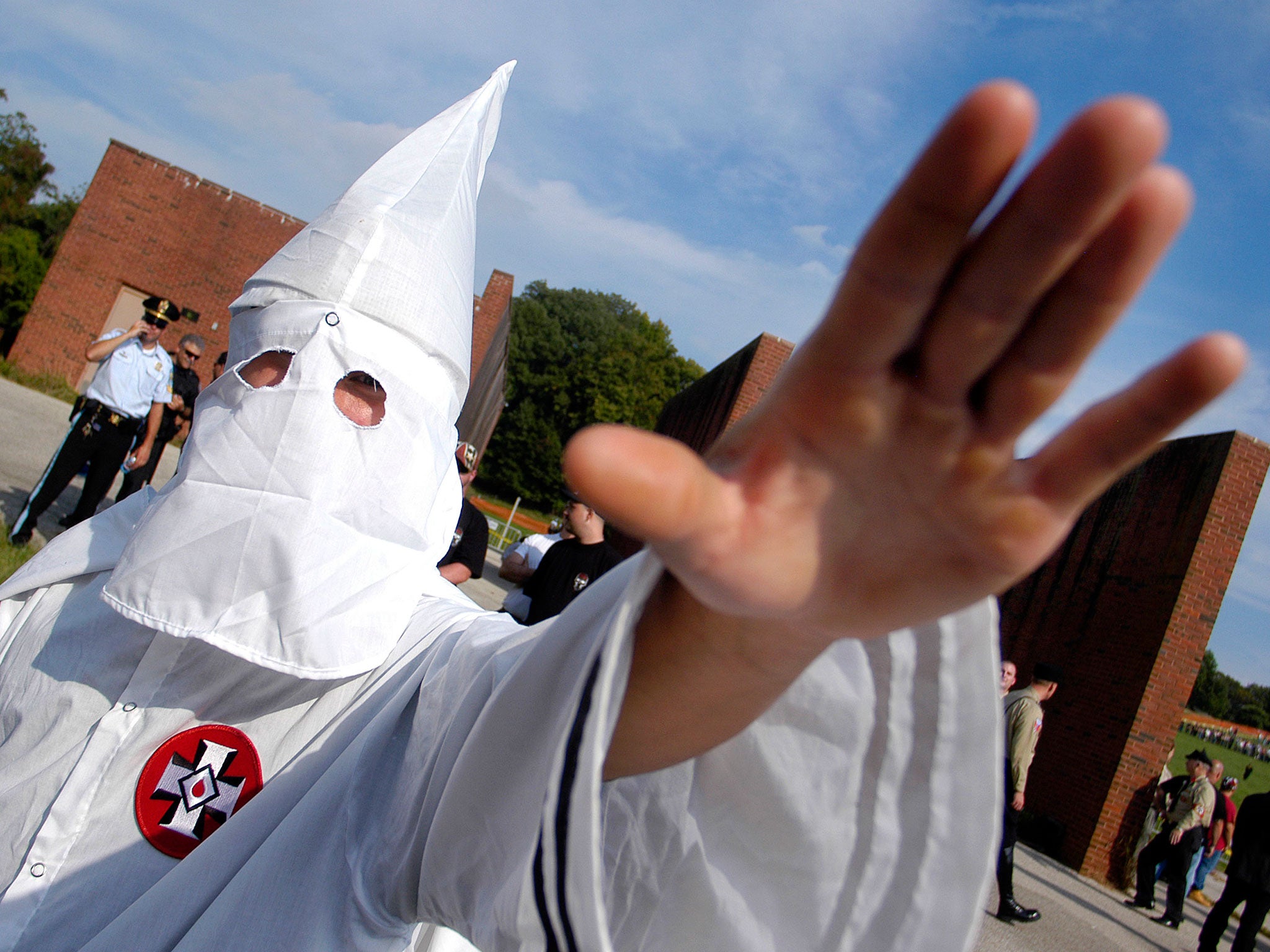 A member of the Ku Klux Klan salutes during an American Nazi Party rally at Valley Forge National Park September 25, 2004, in Valley Forge, Pennsylvania