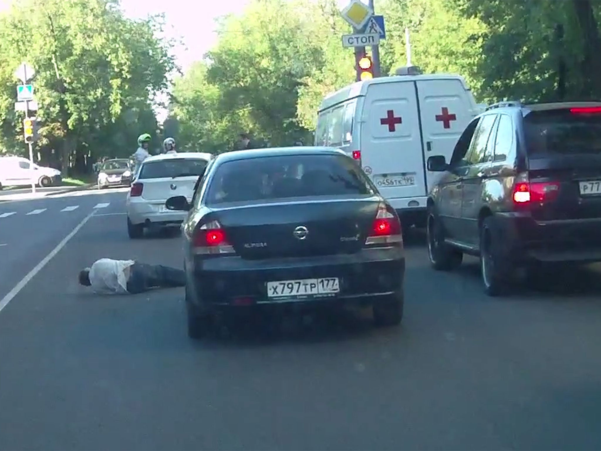 A still from a video appearing to show a driver hit a man with his car