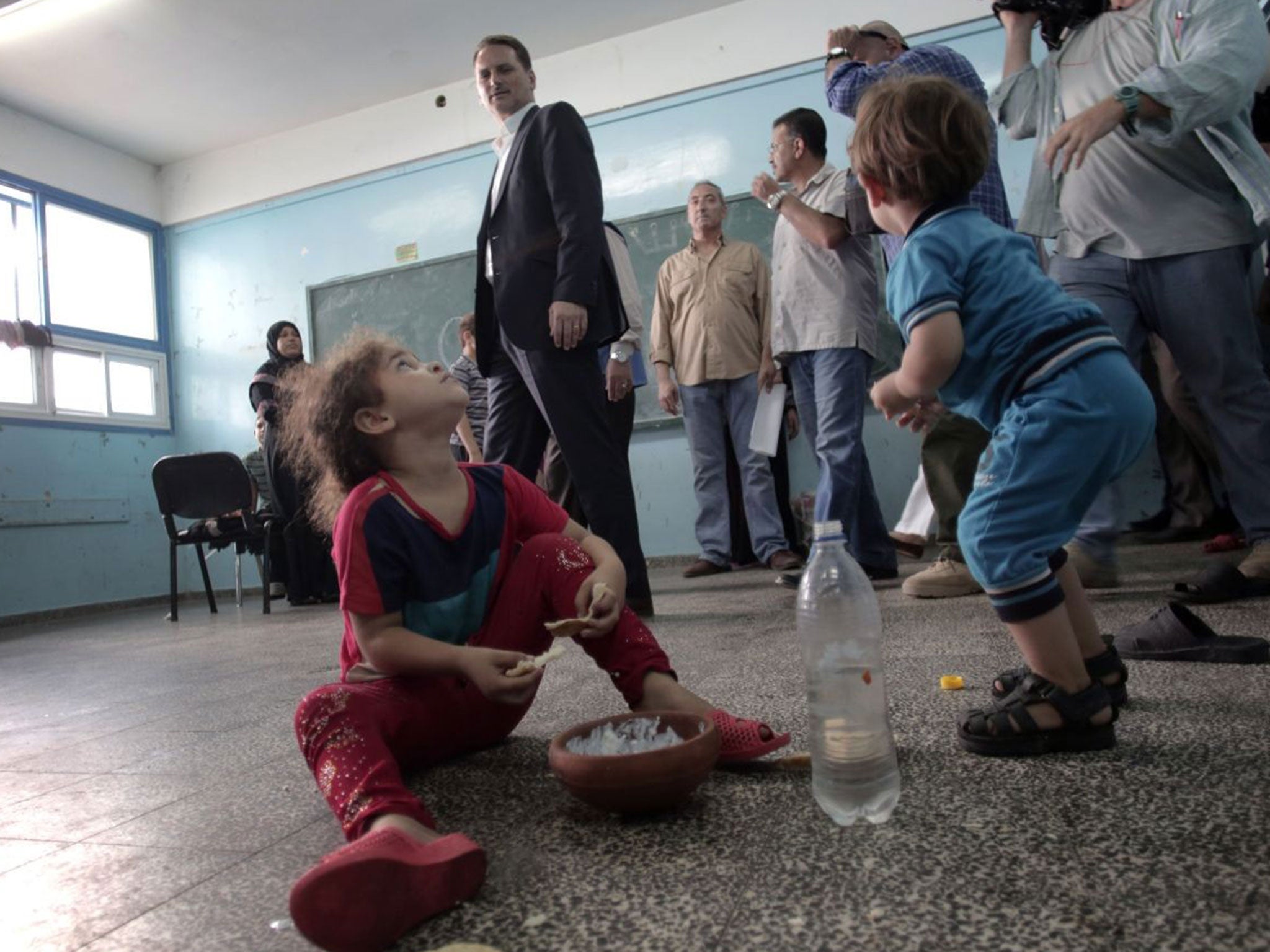 Commissioner-General Pierre Krahenbuhl, of the United Nations Relief and Works Agency for Palestine Refugees in the Near East, surveys the New Gaza Boys United Nations School, where dozens of families have sought refuge after fleeing their home in fear of