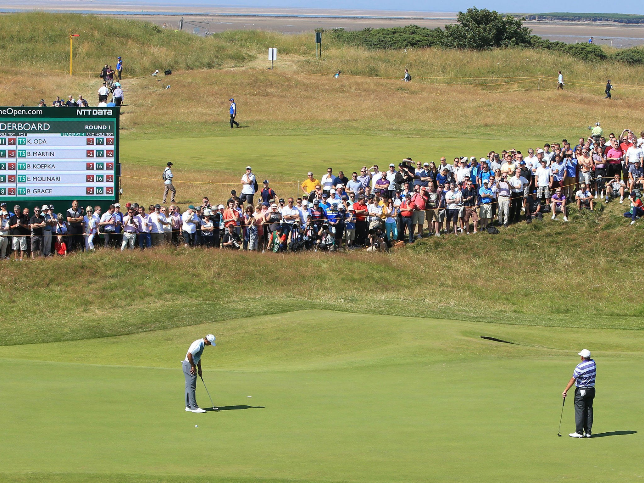 Tiger Woods lines up a putt at Royal Liverpool yesterday