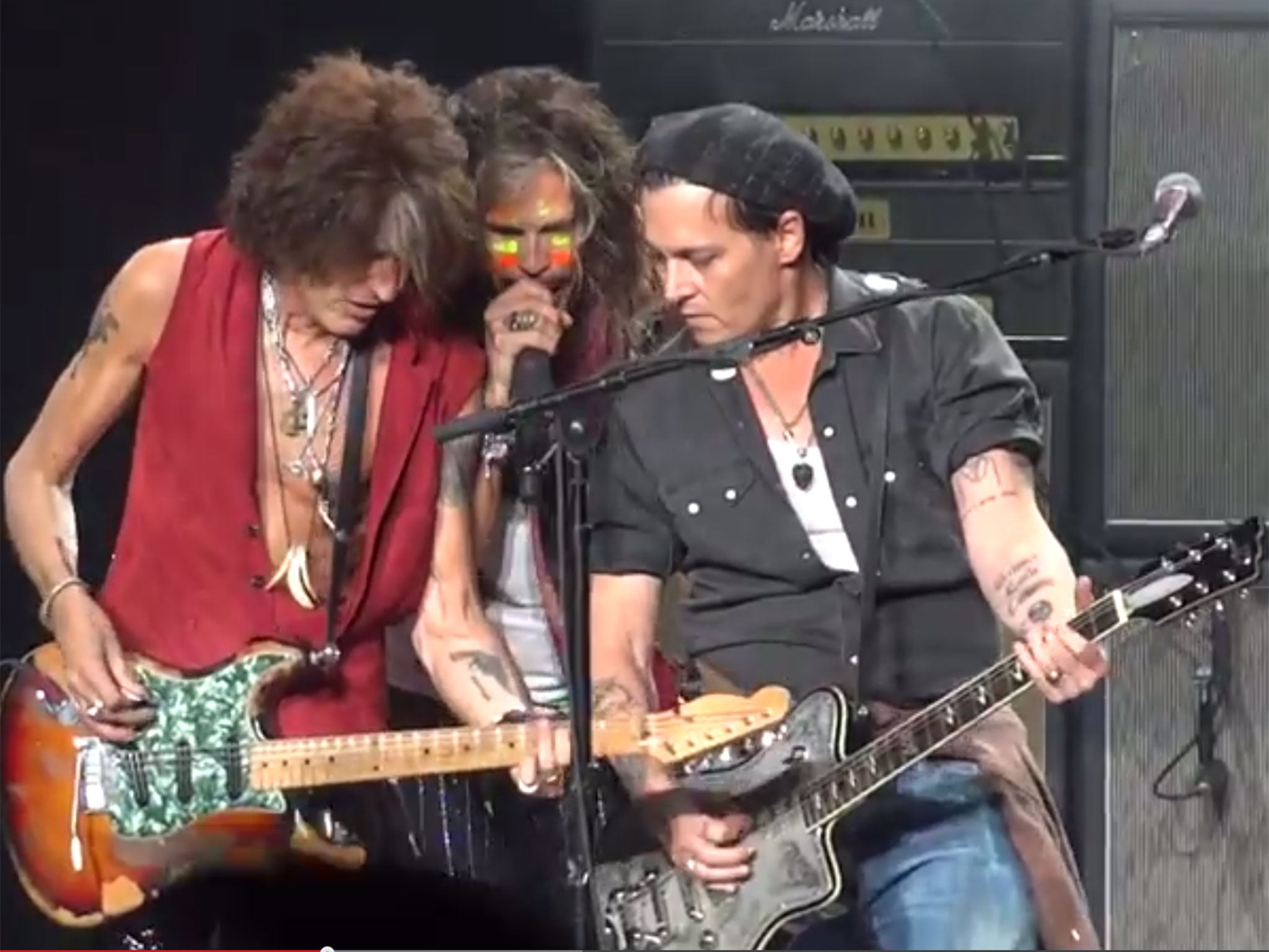 Johnny Depp plays guitar with Aerosmith on stage in Boston