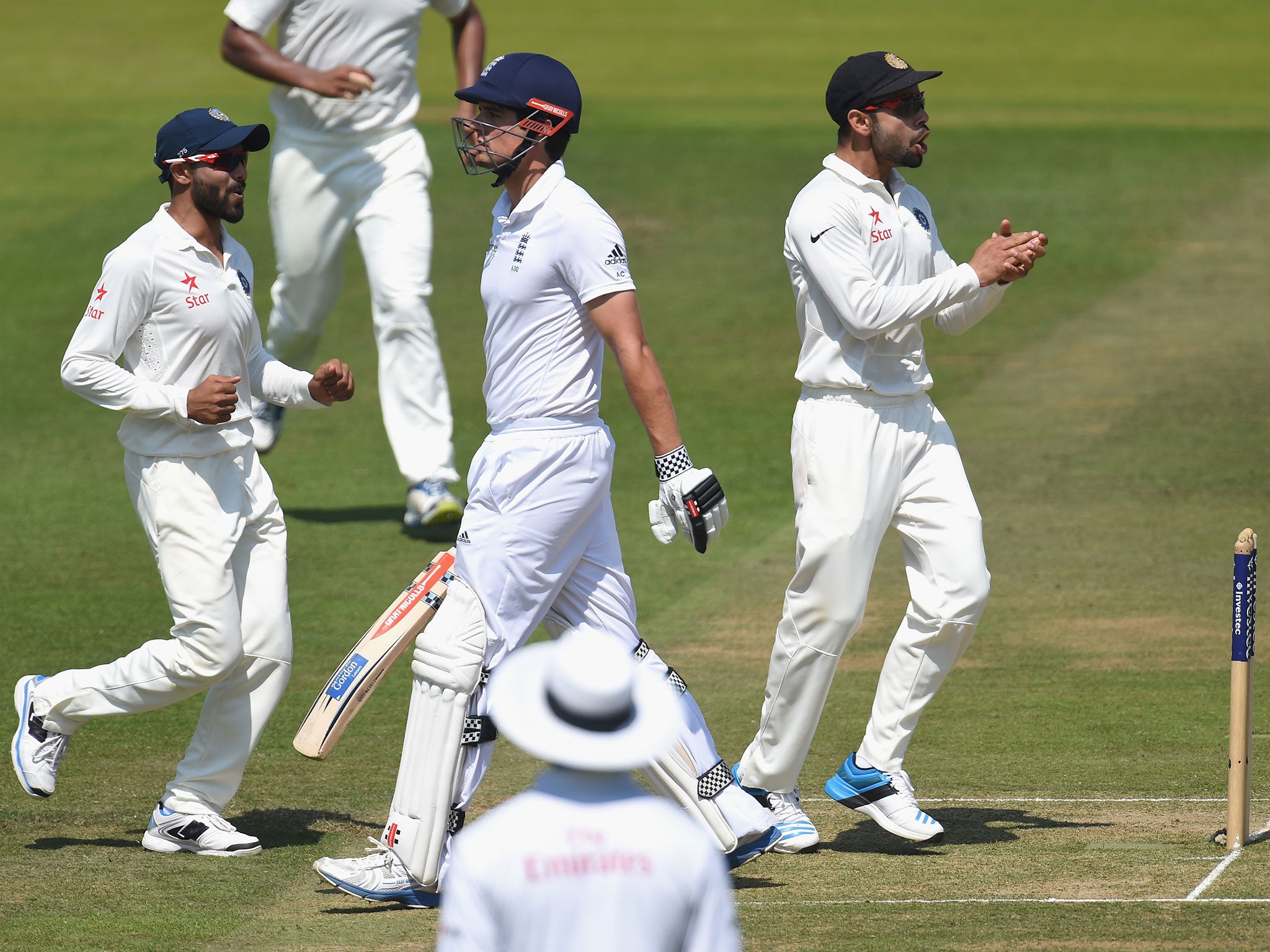 Alaistair Cook walks back to the pavilion after India bowl him out for 10