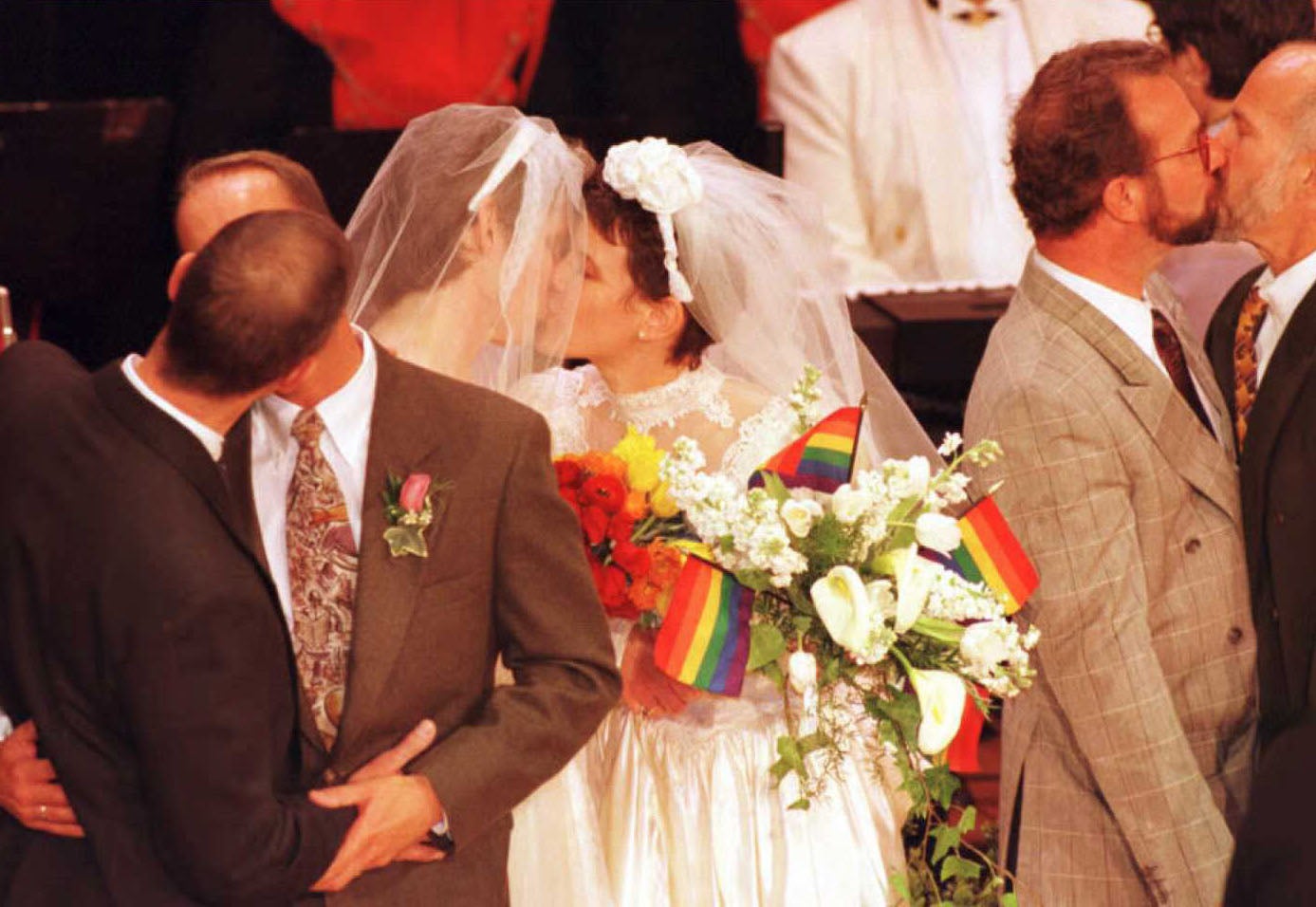 Gay and lesbian couples kiss after exchanging vows during San Francisco's history-making public civil ceremony for domestic partners 25 March in San Francisco