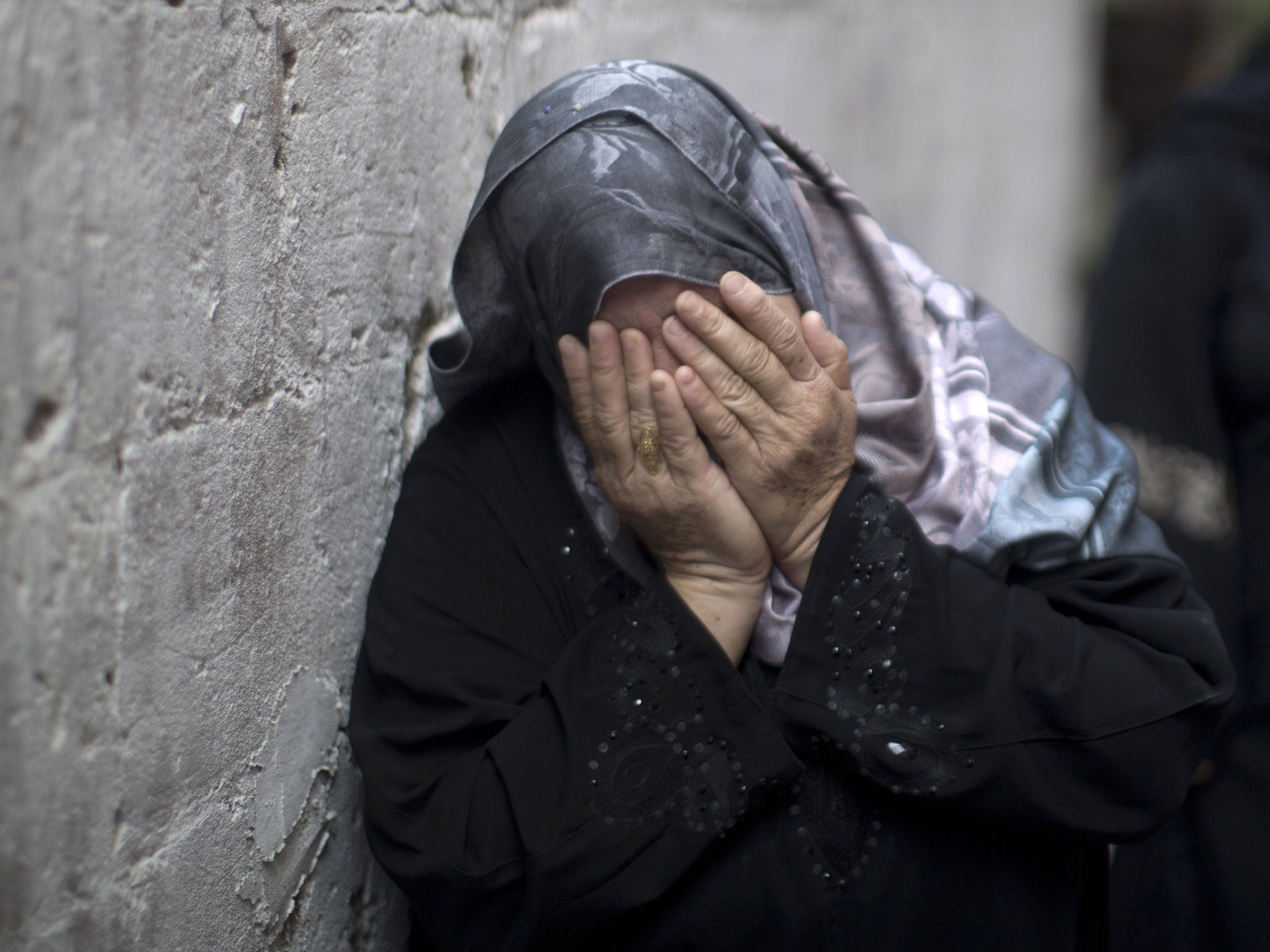 A relative mourns during a funeral