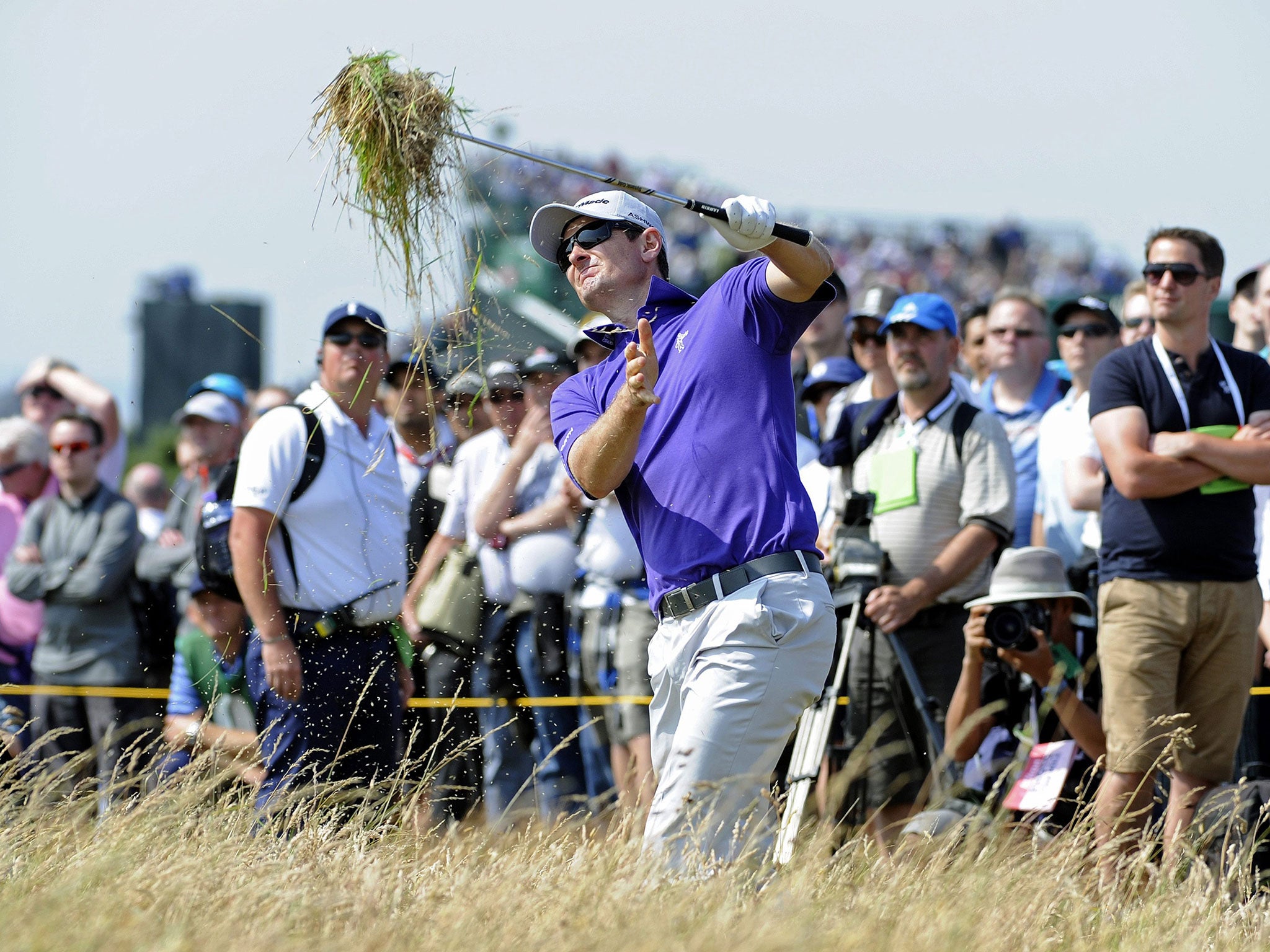 Justin Rose brings in the harvest as he plays out of the rough at the seventh yesterday