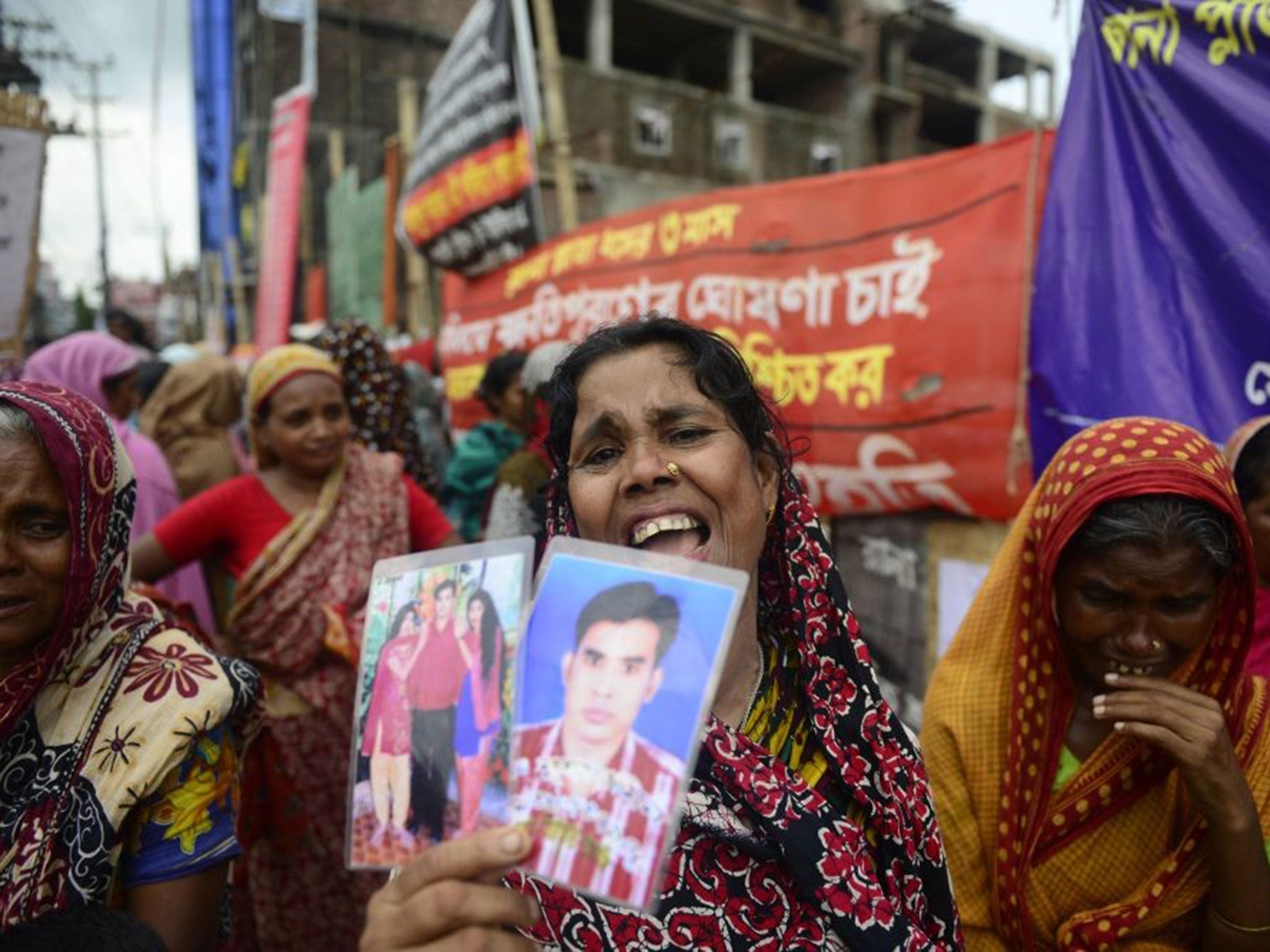 In ruins: Relatives marking the 100th day of the disaster last year