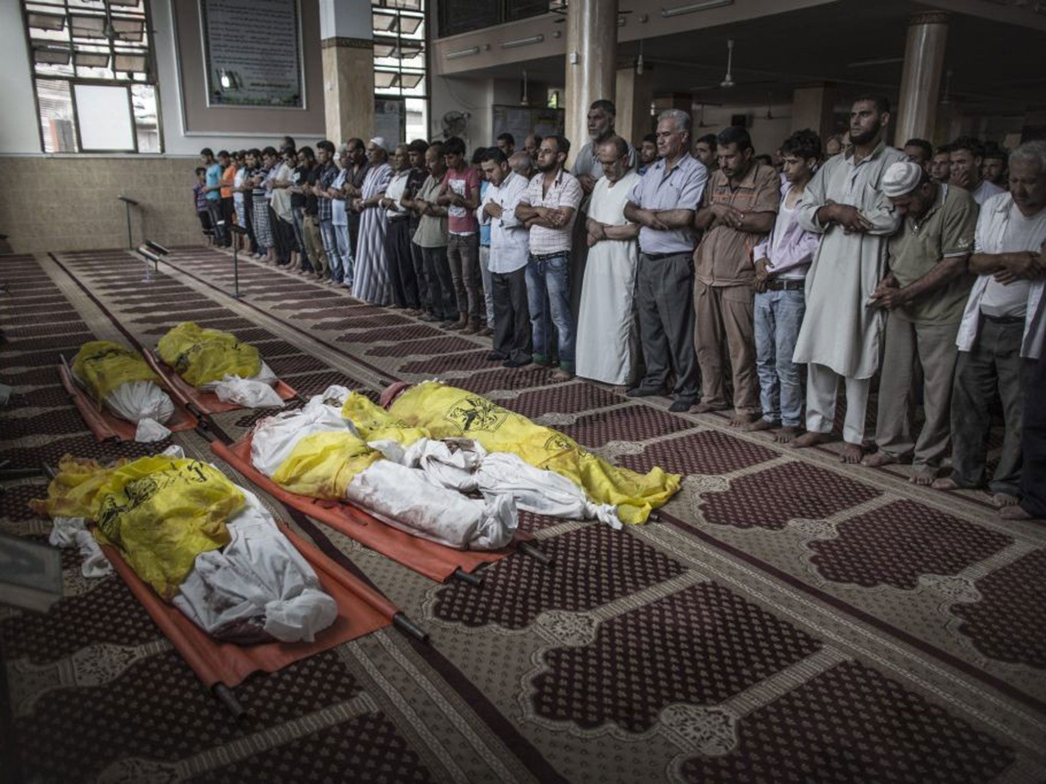 In mourning: Relatives of the Abu Jarad family at the funeral of eight family members