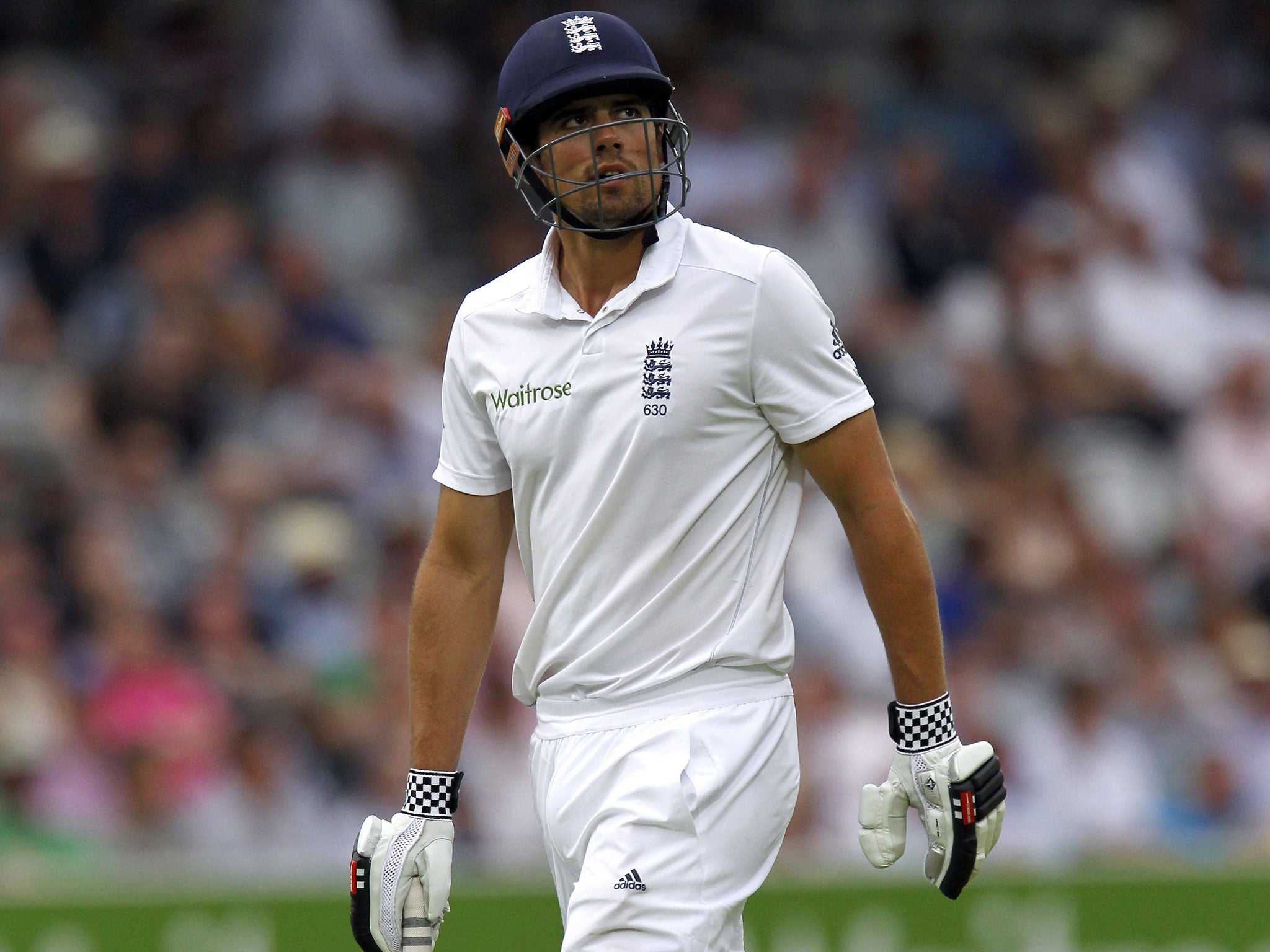 England's Captain Alastair Cook walks back to the pavilion after getting out for 22 runs