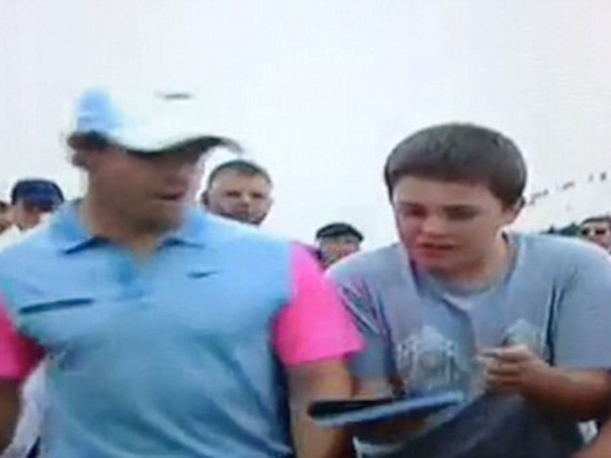 A young fan asks for McIlroy's autograph after he wins the Open