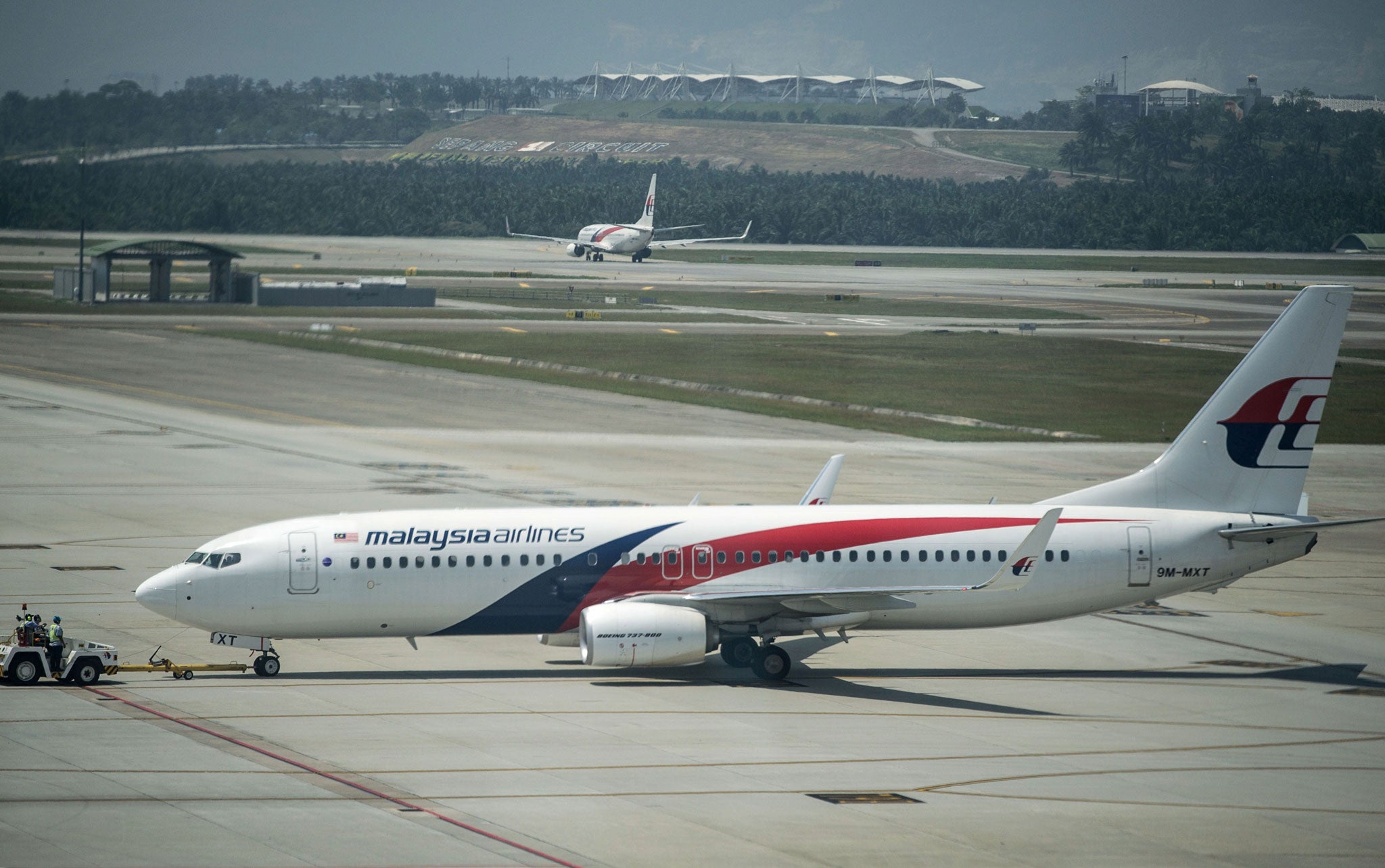 Malaysia Airlines planes are seen on the tarmac at Kuala Lumpur International Airport on 21 July, 2014. Malaysia Airlines said it would offer full refunds to customers who want to cancel their tickets in the wake of the MH17 disaster