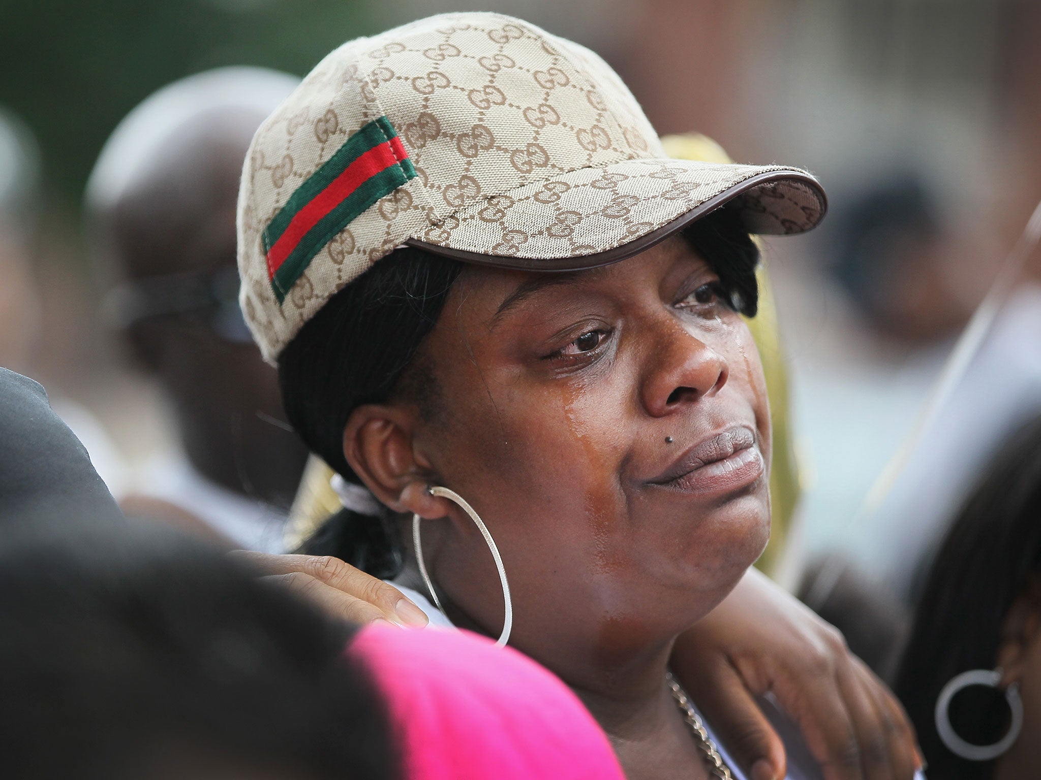 Tears run down the cheeks of Shaneetha Goodloe during a memorial service for her daughter, Shamiya Adams