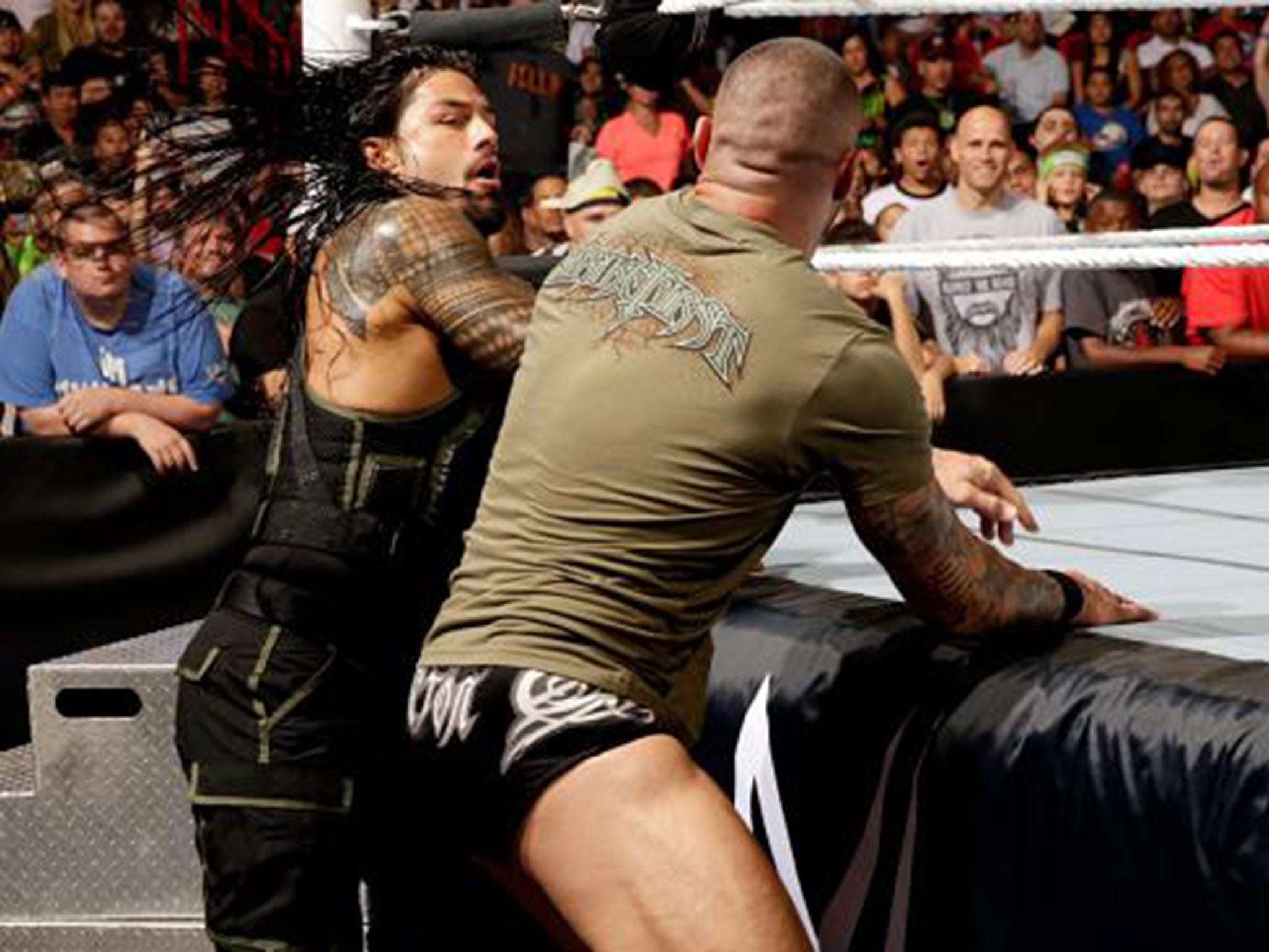 Roman Reigns and Randy Orton battle during the 2-on-1 handicap match