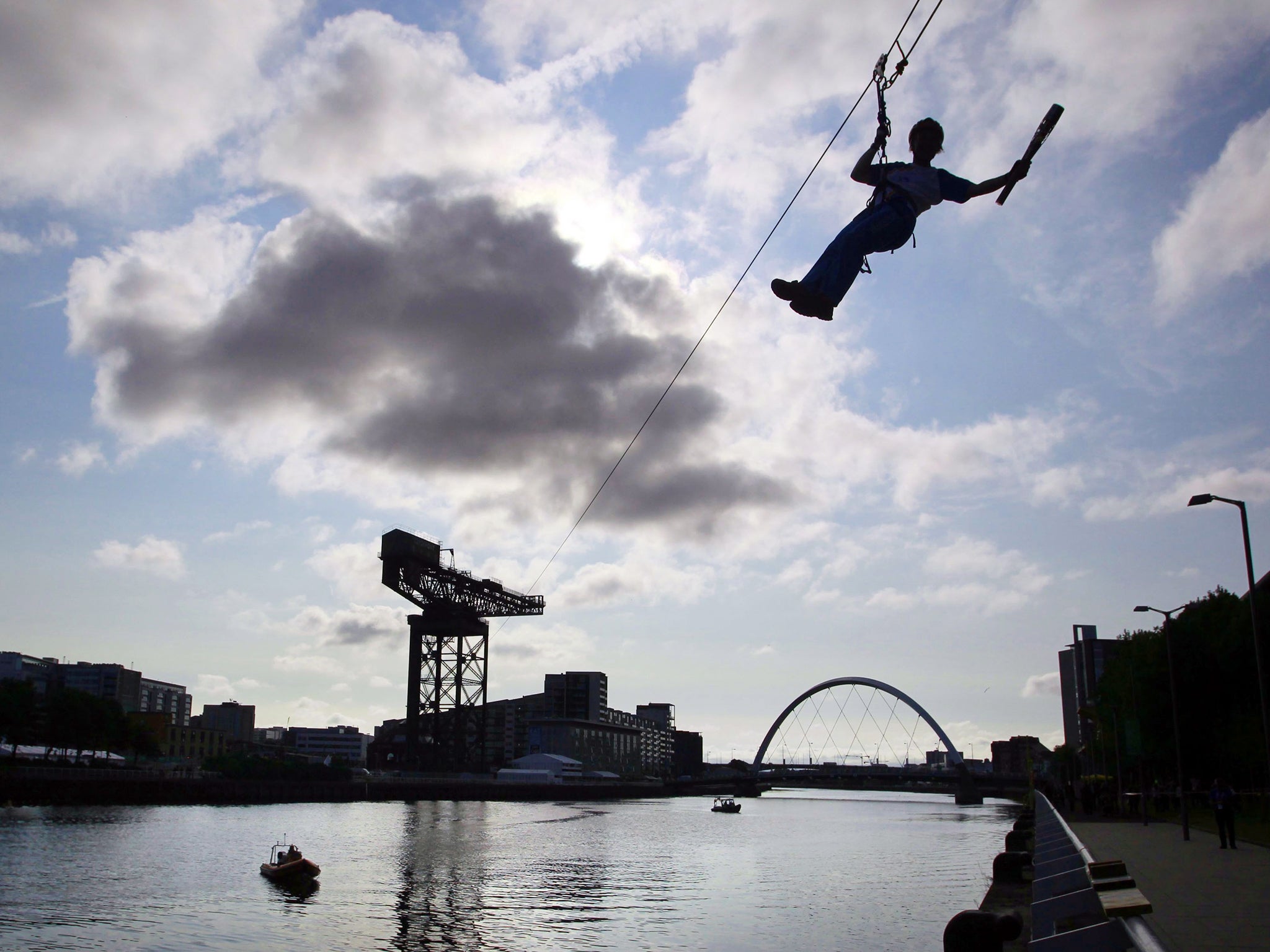 Batonbearer 010 Nina Saunders carrying the Glasgow 2014 Queen's Baton on a zip wire from Finnieston Crane in Glasgow