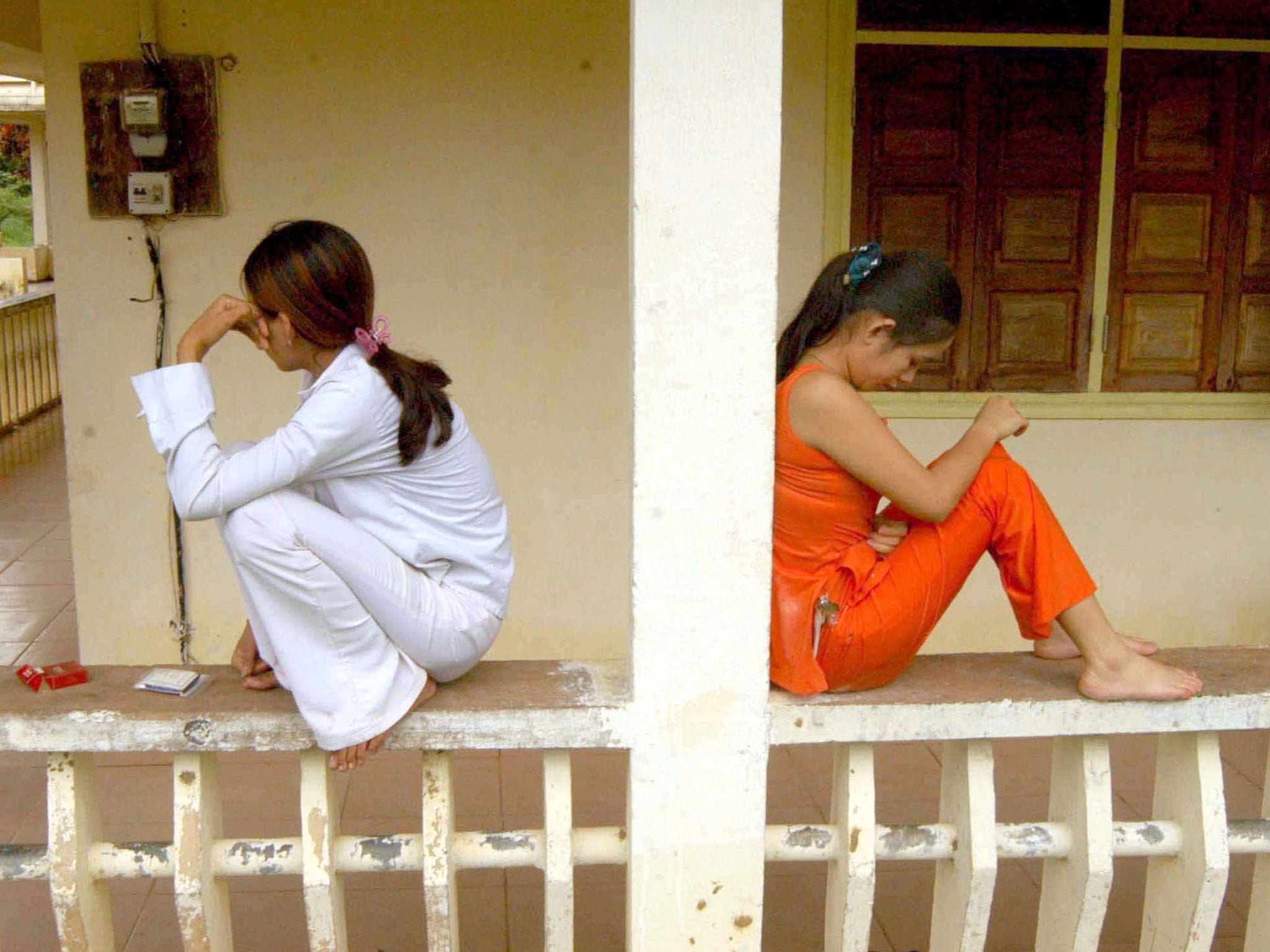 Prostitutes at a clinic in Cambodia wait for the results of blood tests