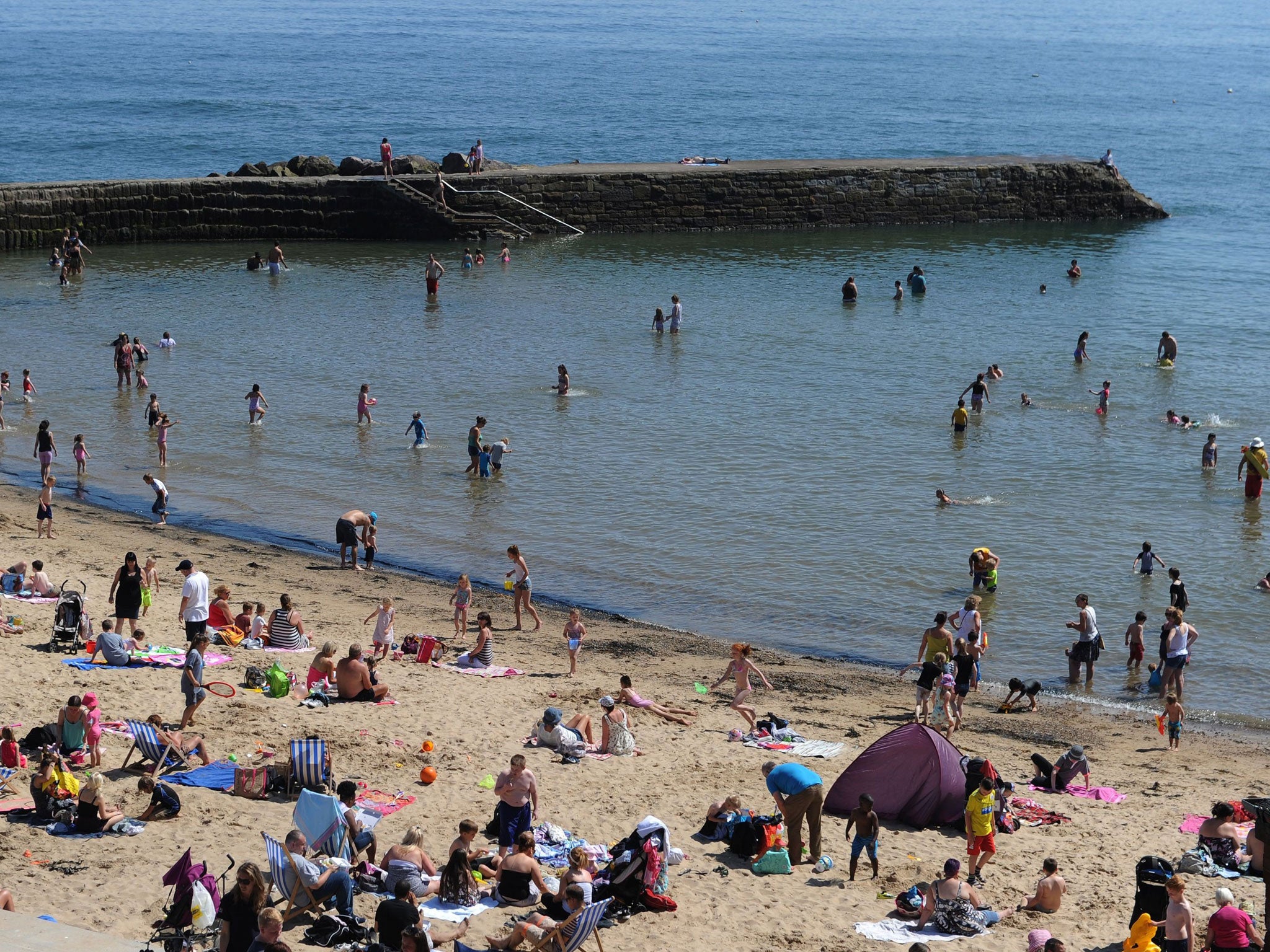 A crowded beach at Cullercoats, North Tyneside as temperatures hit the high 20s on Tuesday 22 July, 2014