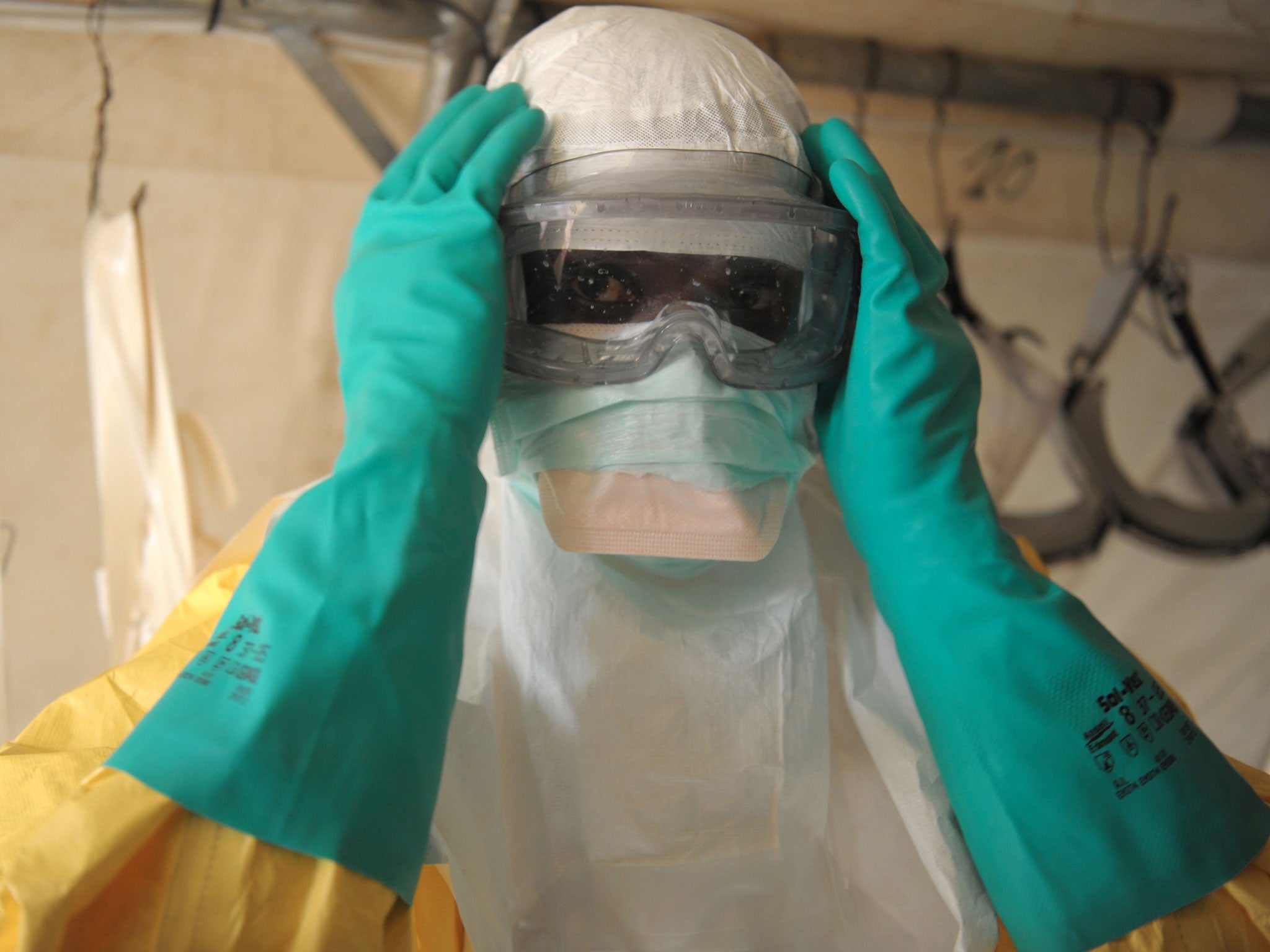 File: Health specialists prepare for work in an isolation ward for patients at the Medecins Sans Frontieres facility in southern Guinea. Guinea's President Alpha Conde warned of a "health emergency" as authorities raced to contain a spiraling Ebola epidem