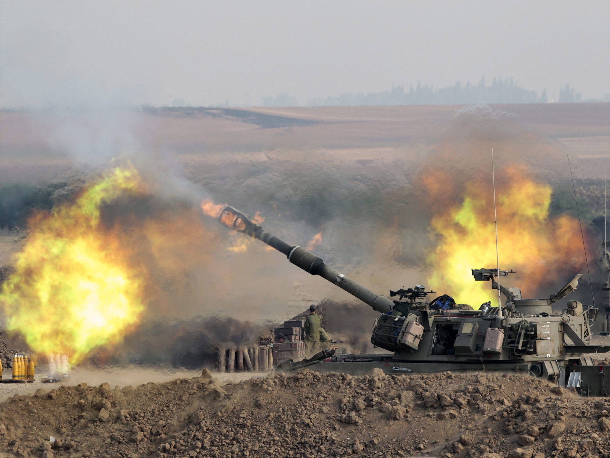 An Israeli 155mm self-propelled howitzer fires from southern Israeli into the Gaza Strip